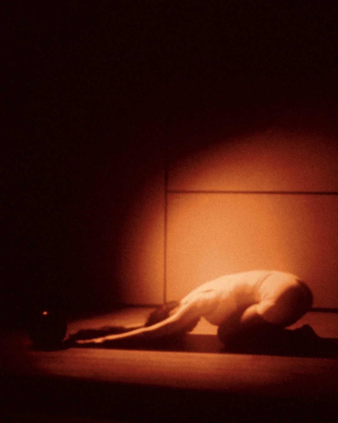 Recovery Flow: child's pose under a soft pool of amber light