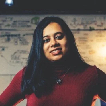 A woman with long dark hair smiling