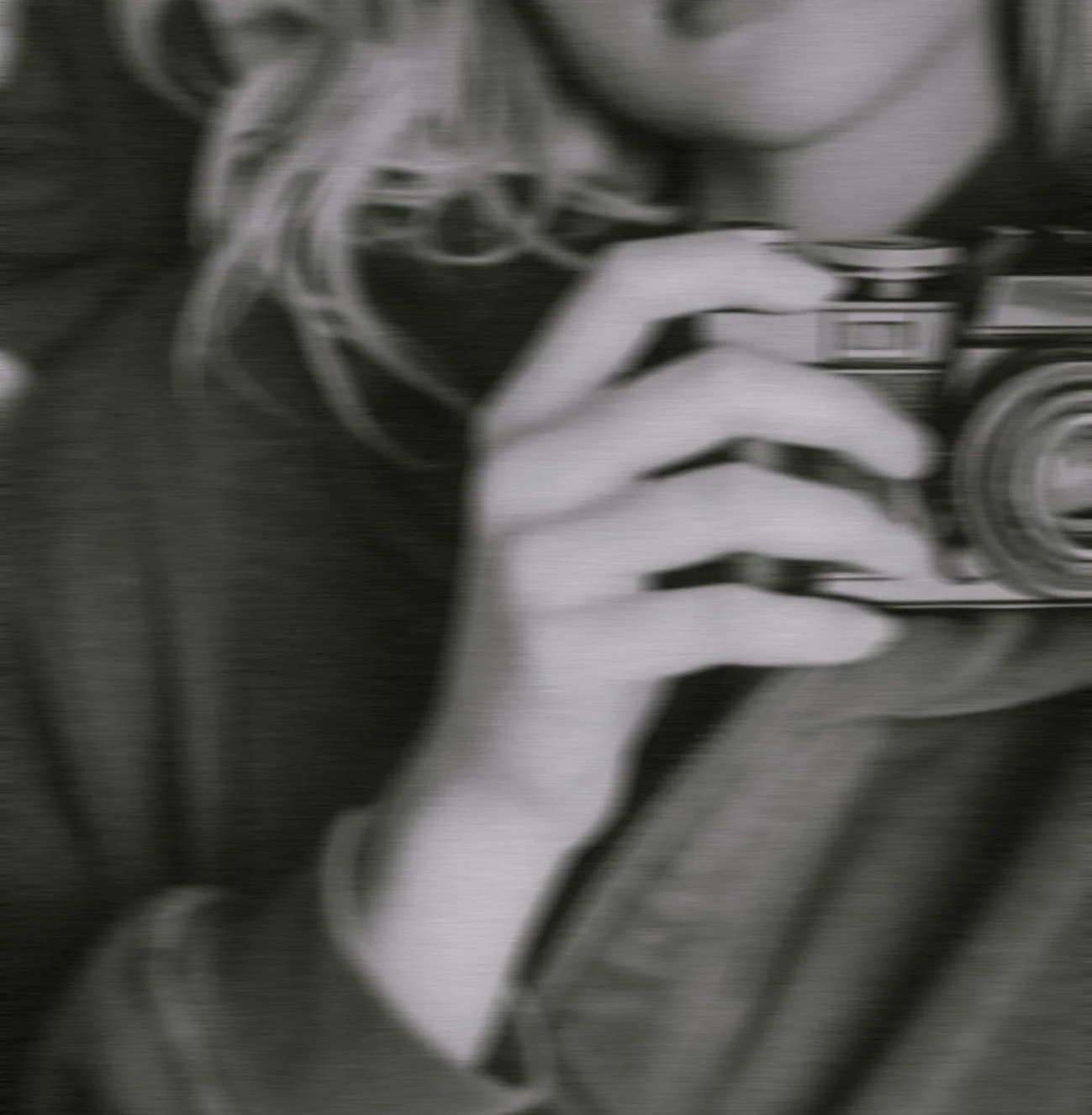 vintage_blurred_woman_holding_camera.jpg