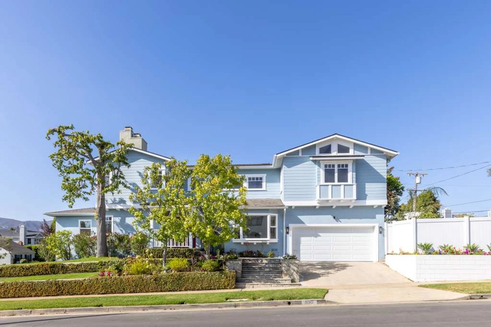 Reconstructed residential home exterior with new siding, windows, and landscaping