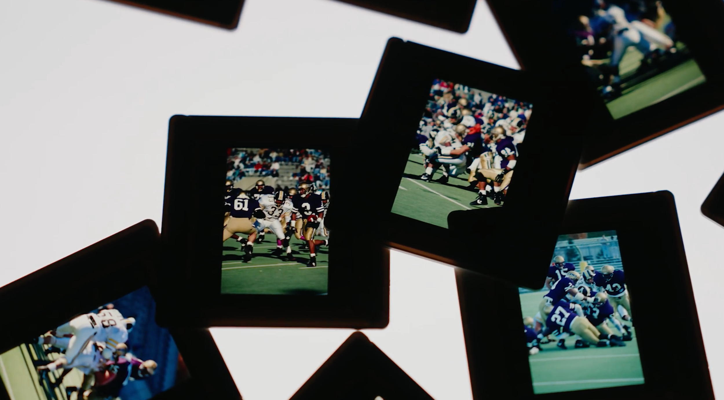 Collection of framed photographs of American football games, arranged in a scattered pattern against a white background.