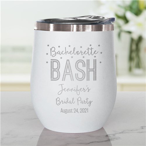 White insulated tumbler with a silver lid, decorated with text for a bridal party celebration, including name and date.