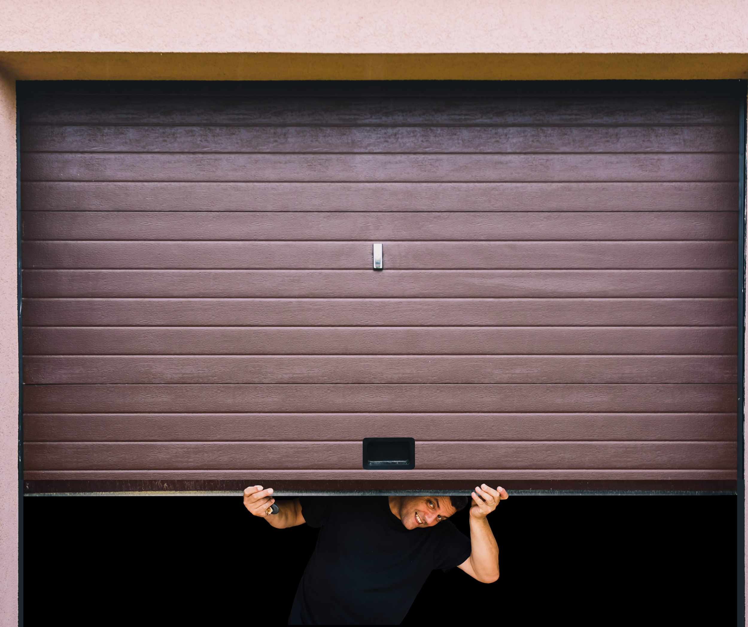 Man holding open garage door.