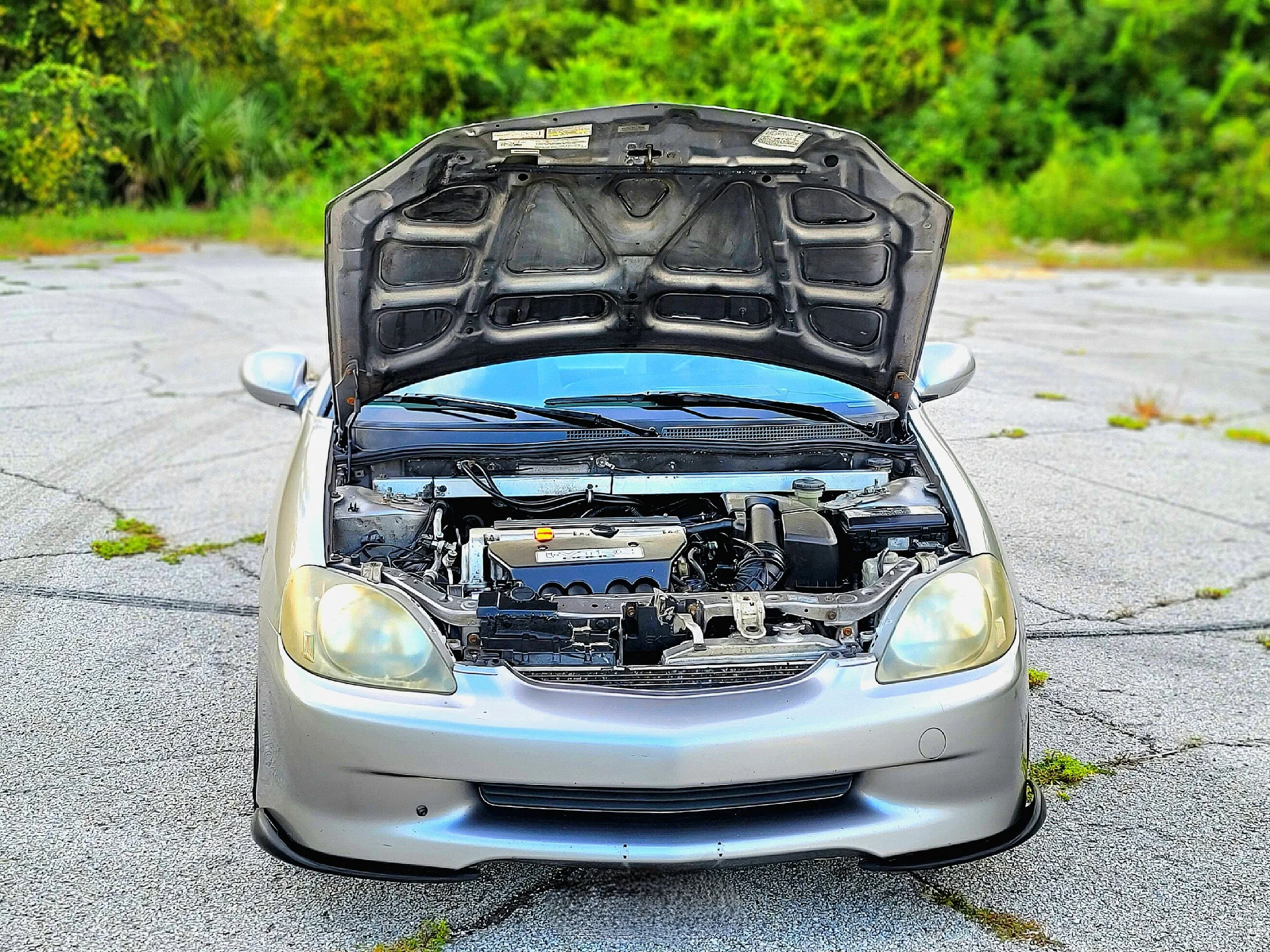 K24 Swapped 2000 Honda ZE1 insight with EP3 stock Air box and Battery relocation to previous Hybrid Battery Pack space. Spare tire also relocated to previous Hybrid Battery pack space next to 12v battery new location. 16in wheels, 5 speed RSX trans