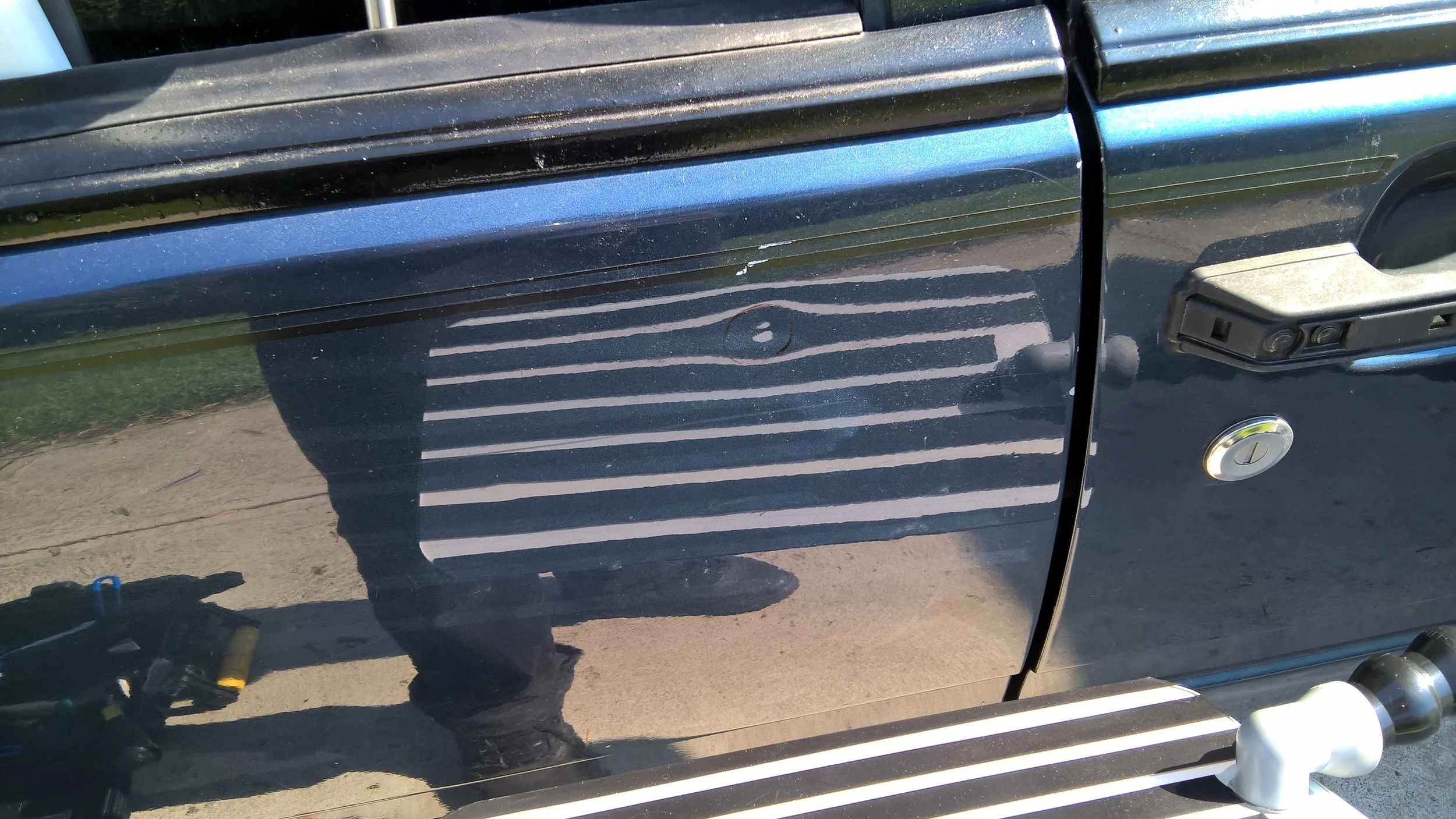 Dent example in 1989 Volvo 740 GLE Wagon Driver Door, Paintless Dent Removal starting $60 at Tigerroad Auto Protection LLC