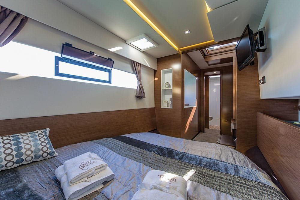 Master stateroom on the Legendary 33 — queen berth with premium linens for World Cup 2026 residency