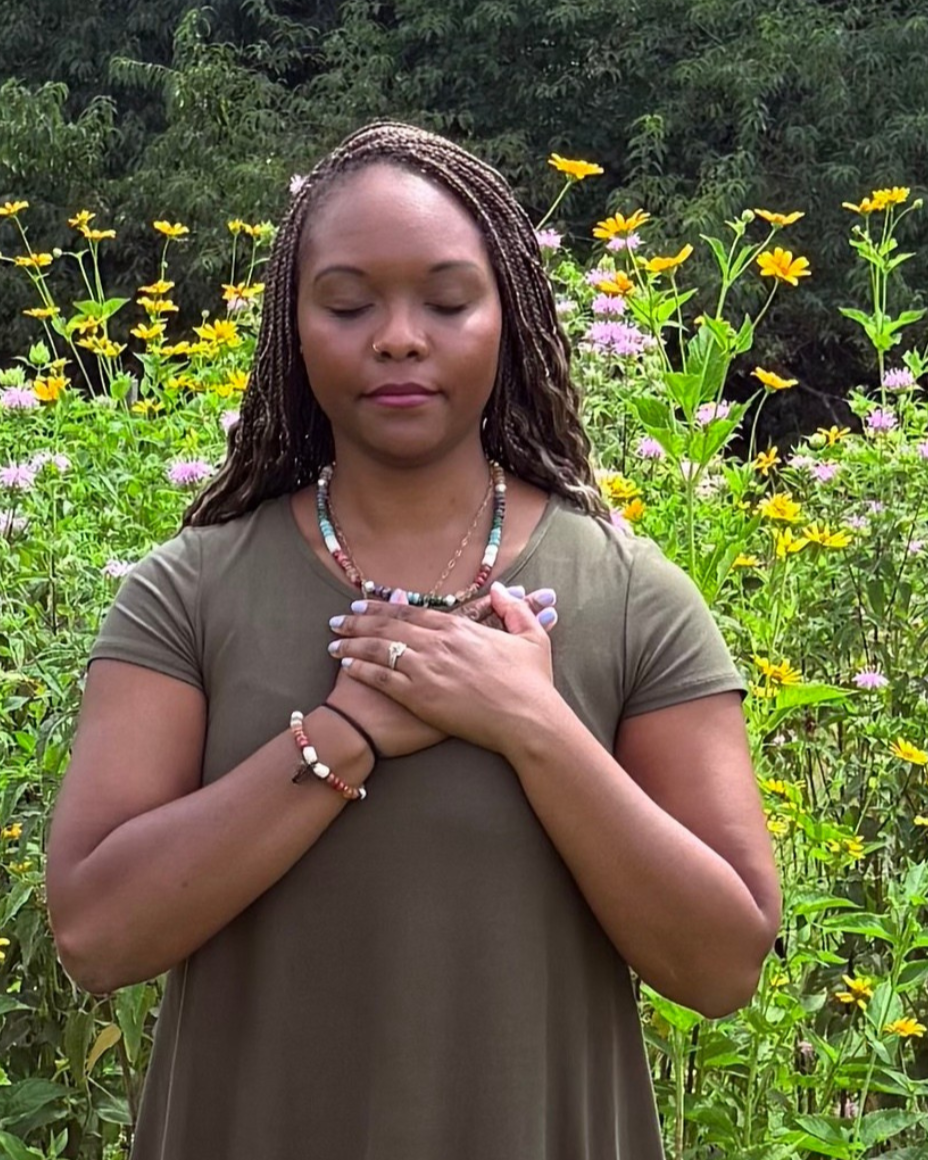 Brittany Steiner demonstrating a self-hug, a gentle somatic therapy technique for cultivating safety and self-compassion.