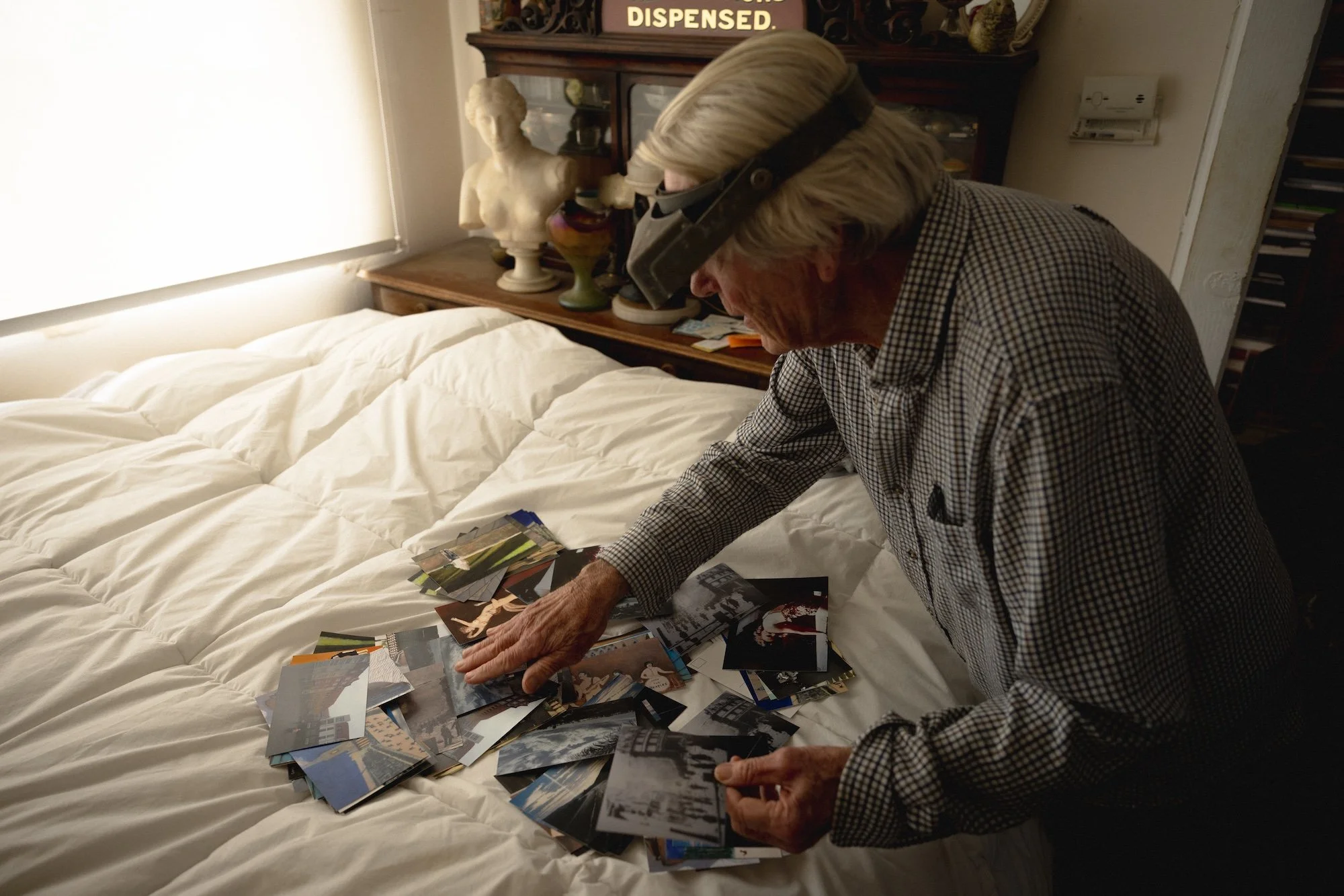 Klaus pulls out a stack of handmade postcards, some bearing his paintings, others his photographs. Among them is a postcard that Klaus took of the site of James Dean’s infamous car crash, alongside another showing the wreckage itself.