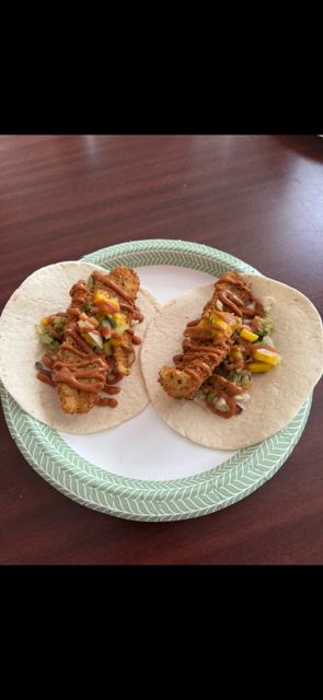 Fresh fish tacos topped with the sizzle sauce and homemade mango salsa