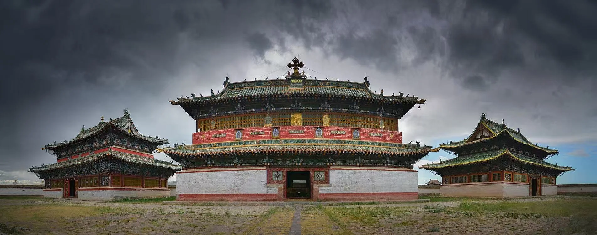 A traditional Asian temple with intricate architectural details and multi-tiered roofs under a dark, stormy sky.