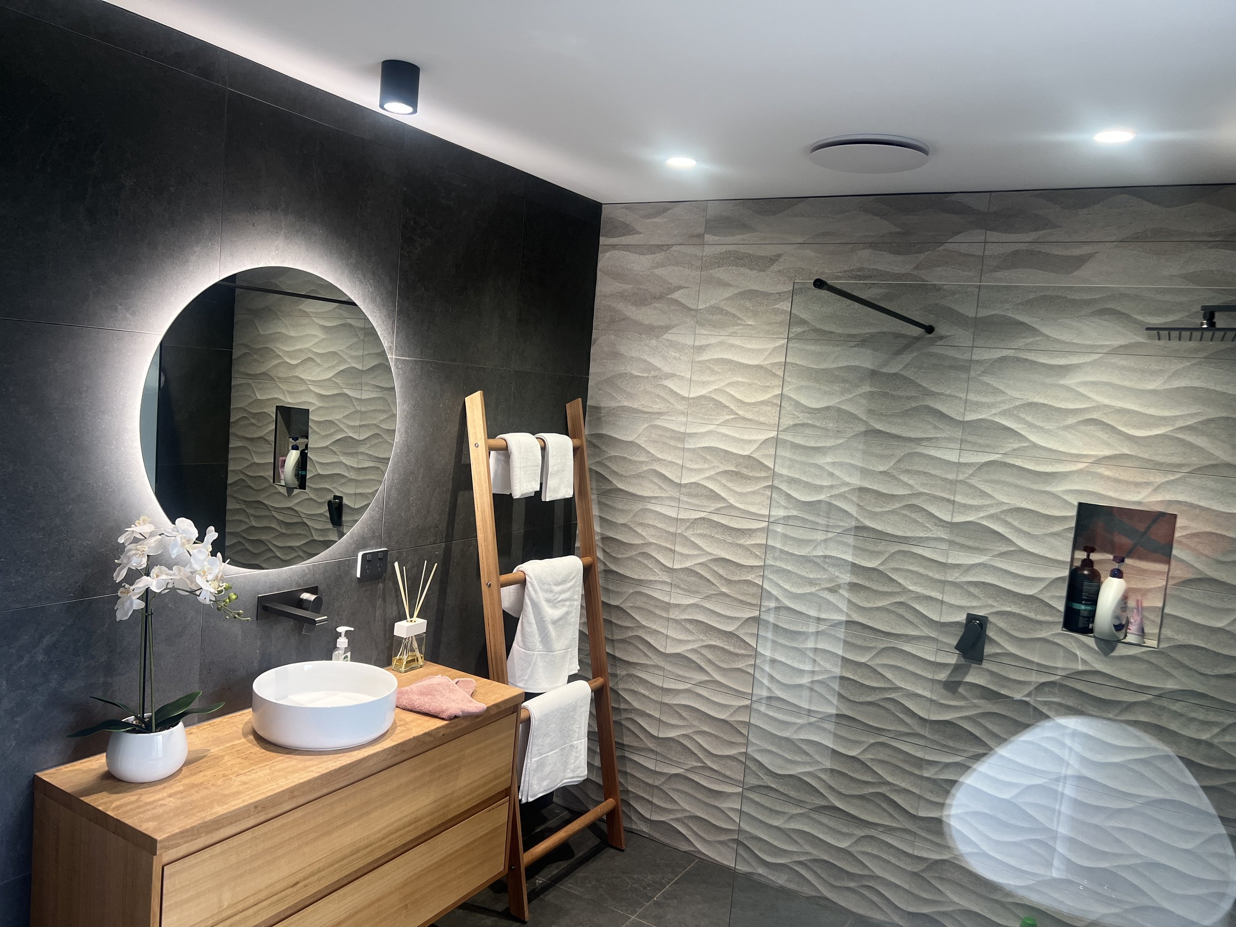 Modern bathroom renovation with LED down lights, LED mirror light and LED can lights