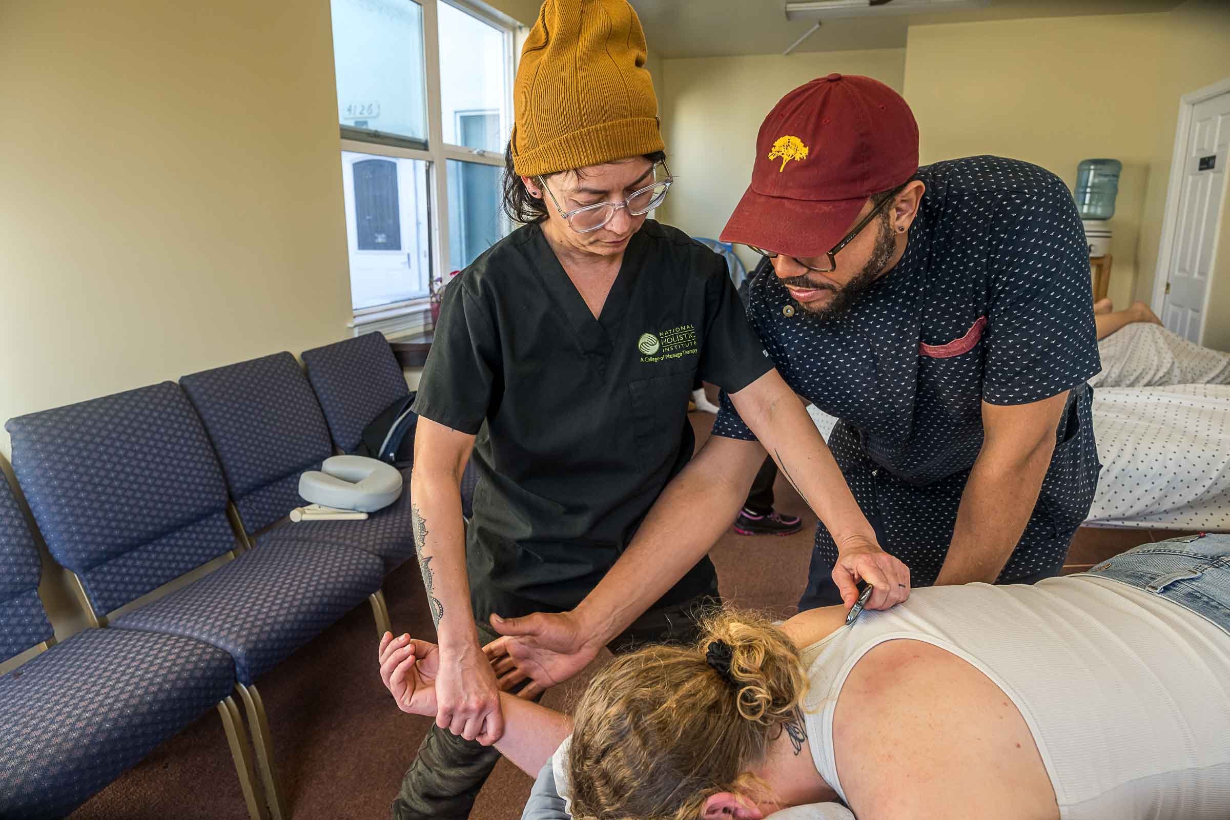 A healthcare professional providing physical therapy or chiropractic treatment to a patient lying on a table.