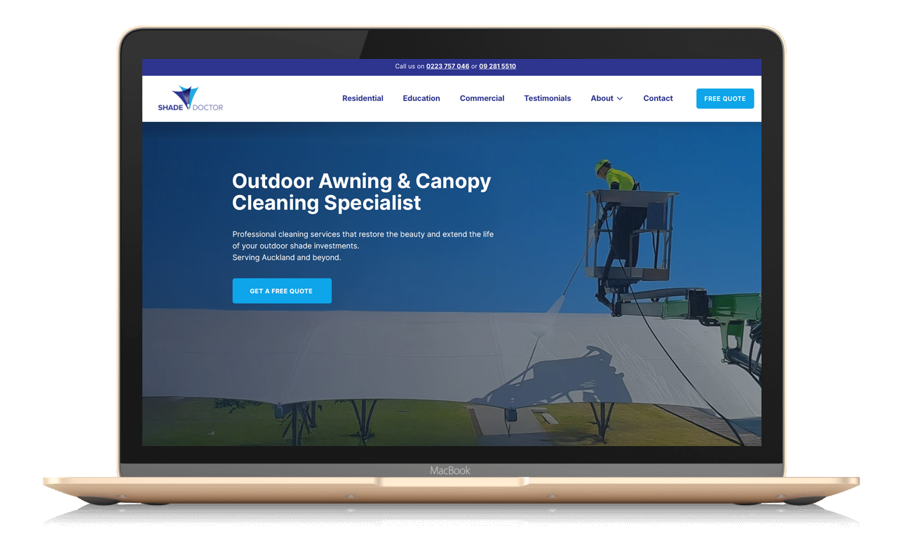 Screenshot of a laptop displaying a website for Shade Doctor, a service specializing in outdoor awning and canopy cleaning. The page features a worker on a lift cleaning a large white canopy against a blue sky, with navigation menu and contact information visible at the top.