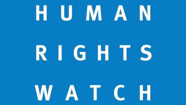Text reading 'HUMAN RIGHTS WATCH' on a blue background.