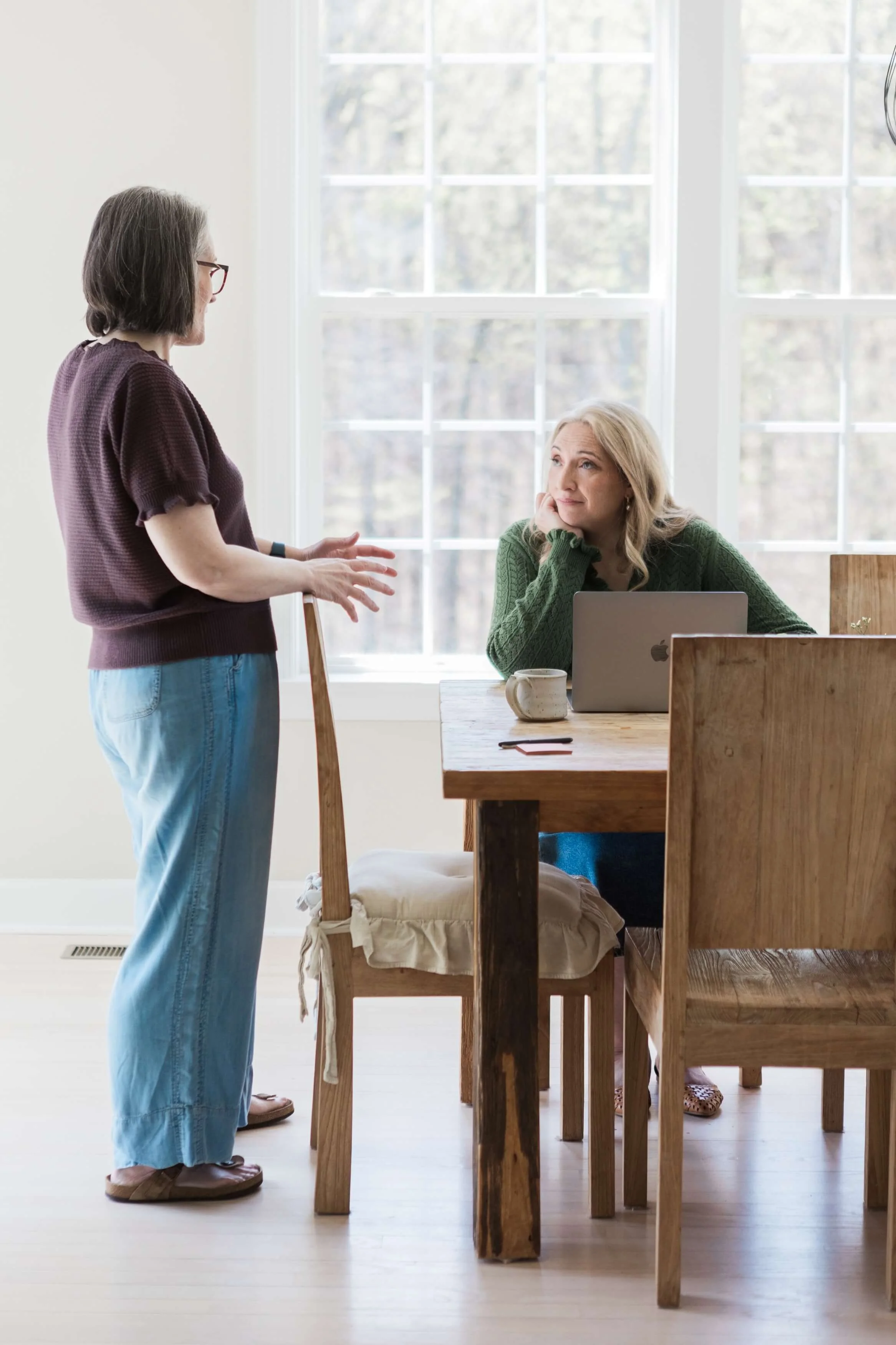 Therapist speaking with a client during an in-person therapy session
