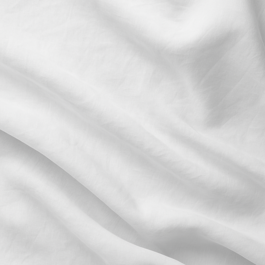 Close-up of white fabric with soft folds and creases.