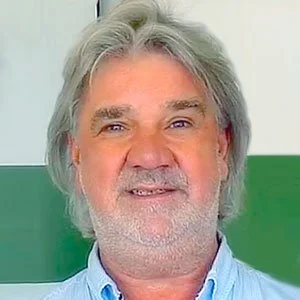 Carsten Jacob mit blauer Hemd, im Hintergrund grün-weiße Wand