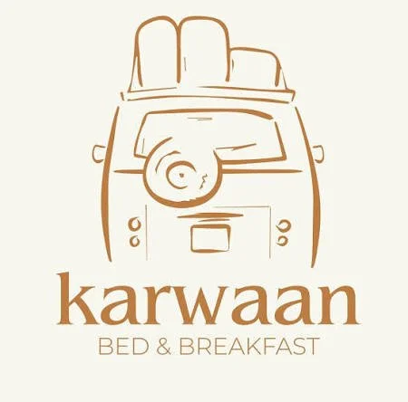 Logo of Karwaan Bed & Breakfast featuring a simple line drawing of a camper van with a bed on top and the name 'Karwaan Bed & Breakfast' below.