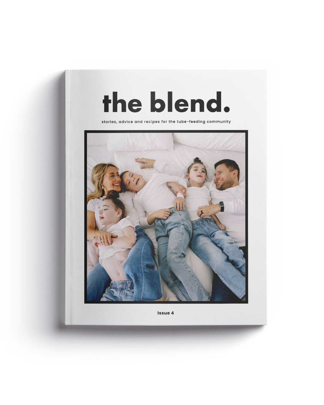 Magazine titled 'the blend.' featuring a photo of a family lying together in bed, with three children and two adults.