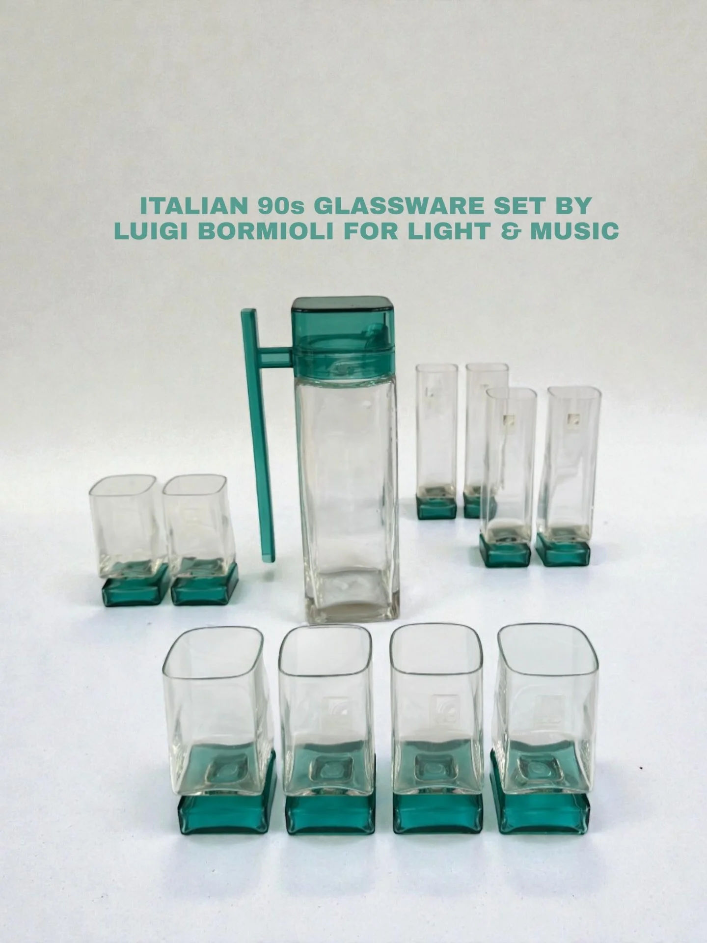 Italian 90s glassware by Luigi Bormioli for Light &amp; Music. Deadstock. Never used, label stickers still on. Pitcher + four champagne flutes + six water glasses. Clear glass, teal base, square form.

#vintage #vintageglass #luigibormioli #italiande