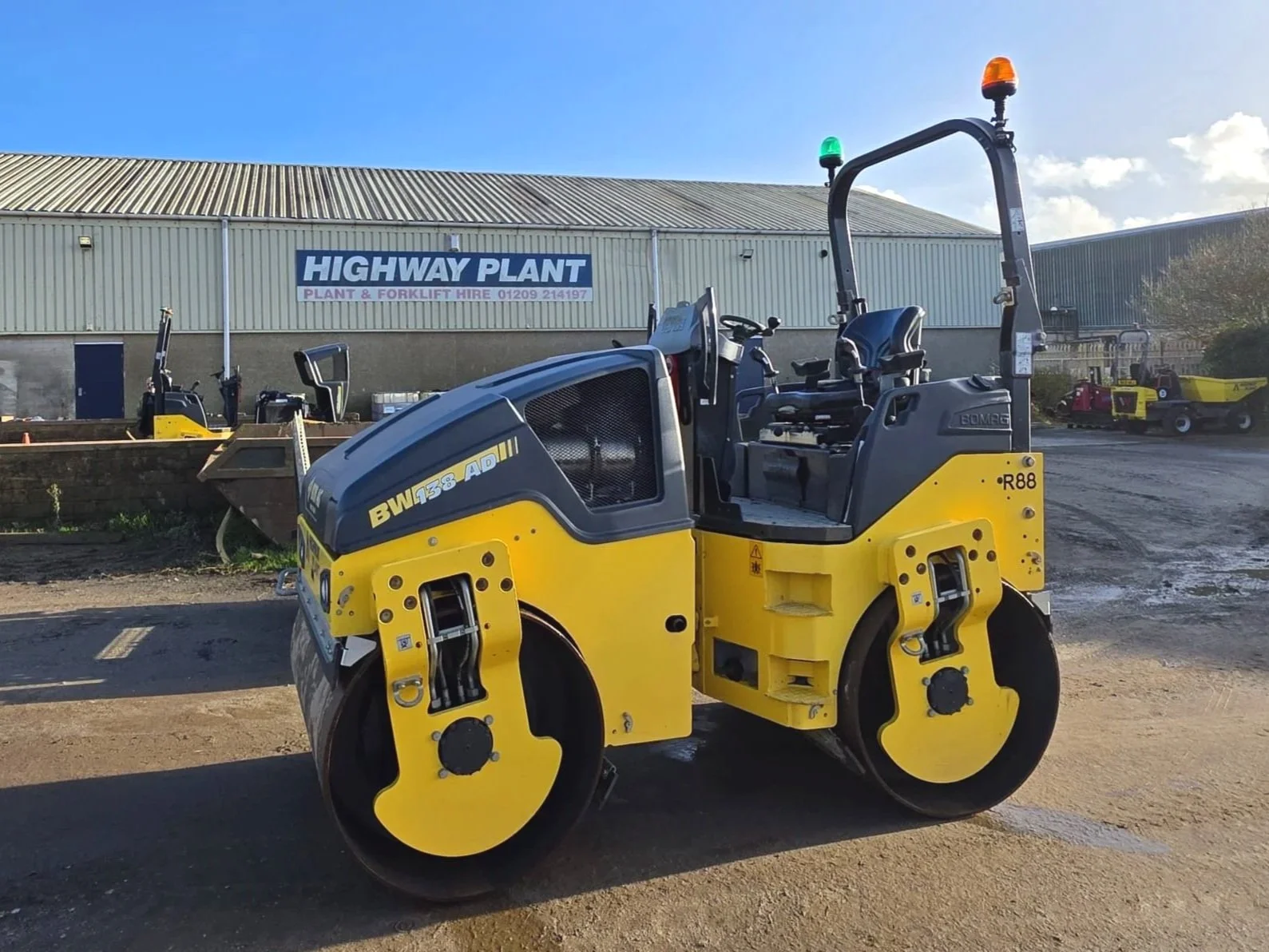A yellow and black road roller for hire in Cornwall and Devon