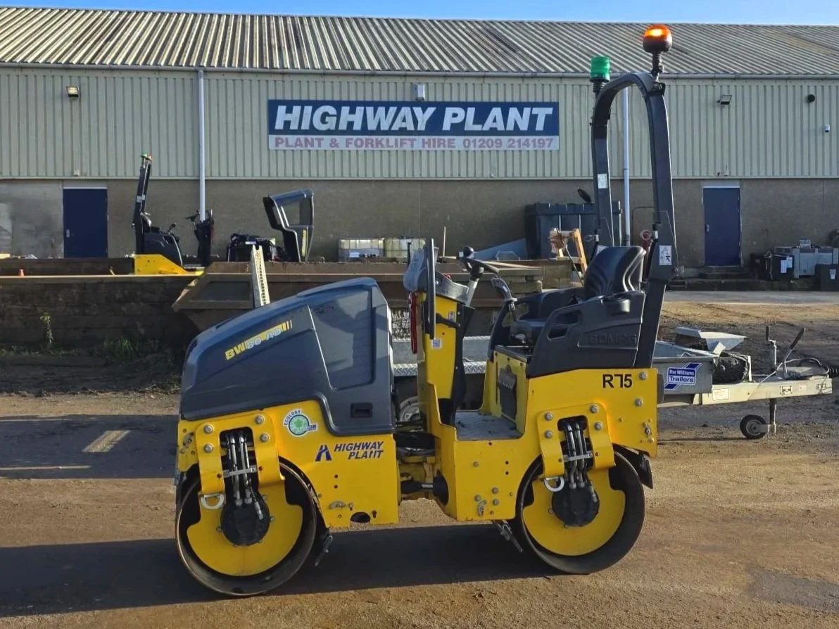 A bright yellow and black road roller for hire in Cornwall and Devon