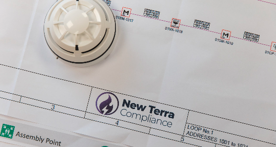 Close-up of a smoke detector on a technical diagram or blueprint.