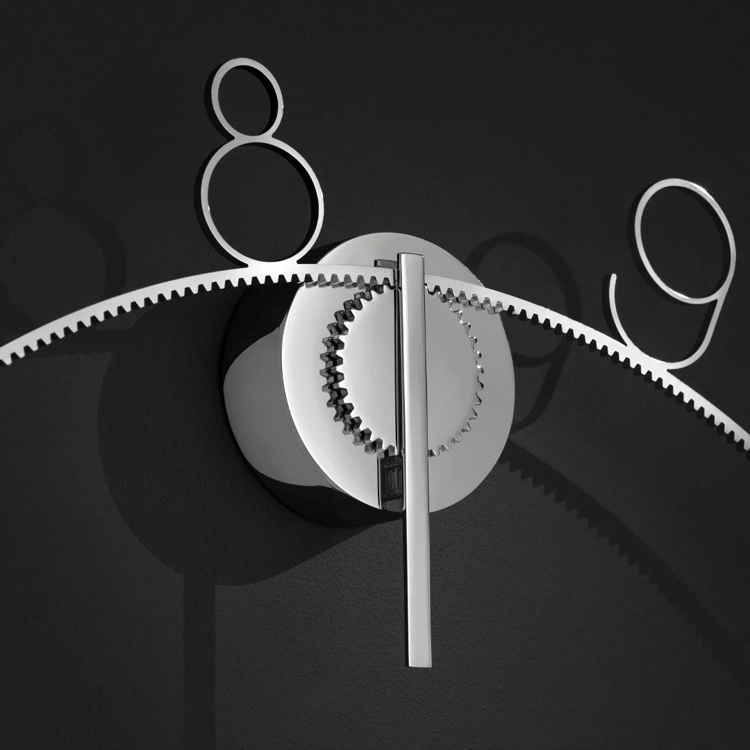 Modern interior clock with black background and metallic gears.