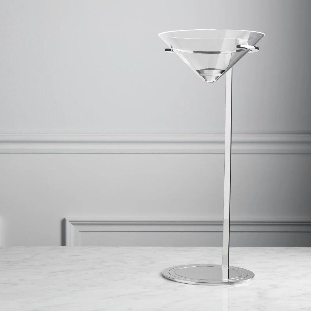 Modern minimalist black and clear cocktail shaker on a white marble countertop against light gray wall.