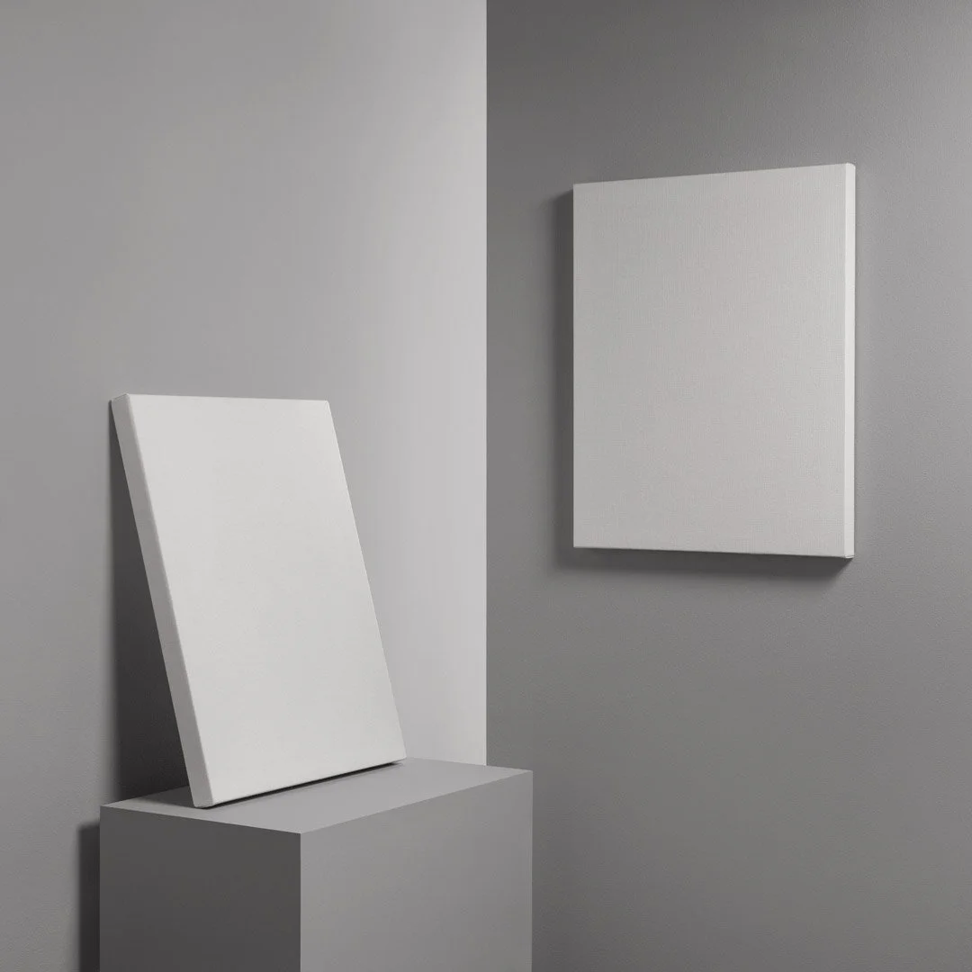Empty white canvases in a minimal art gallery with gray walls, one leaning on a pedestal and the other mounted on the wall.