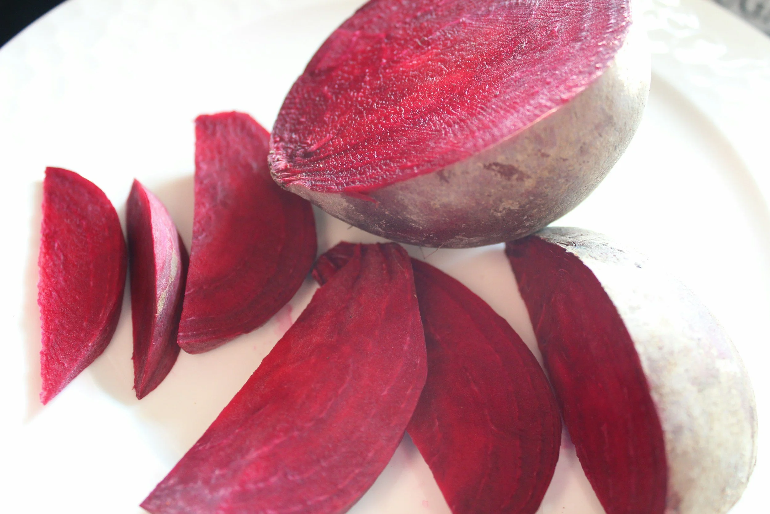 Fresh beetroot cut into wedges showing its deep red flesh