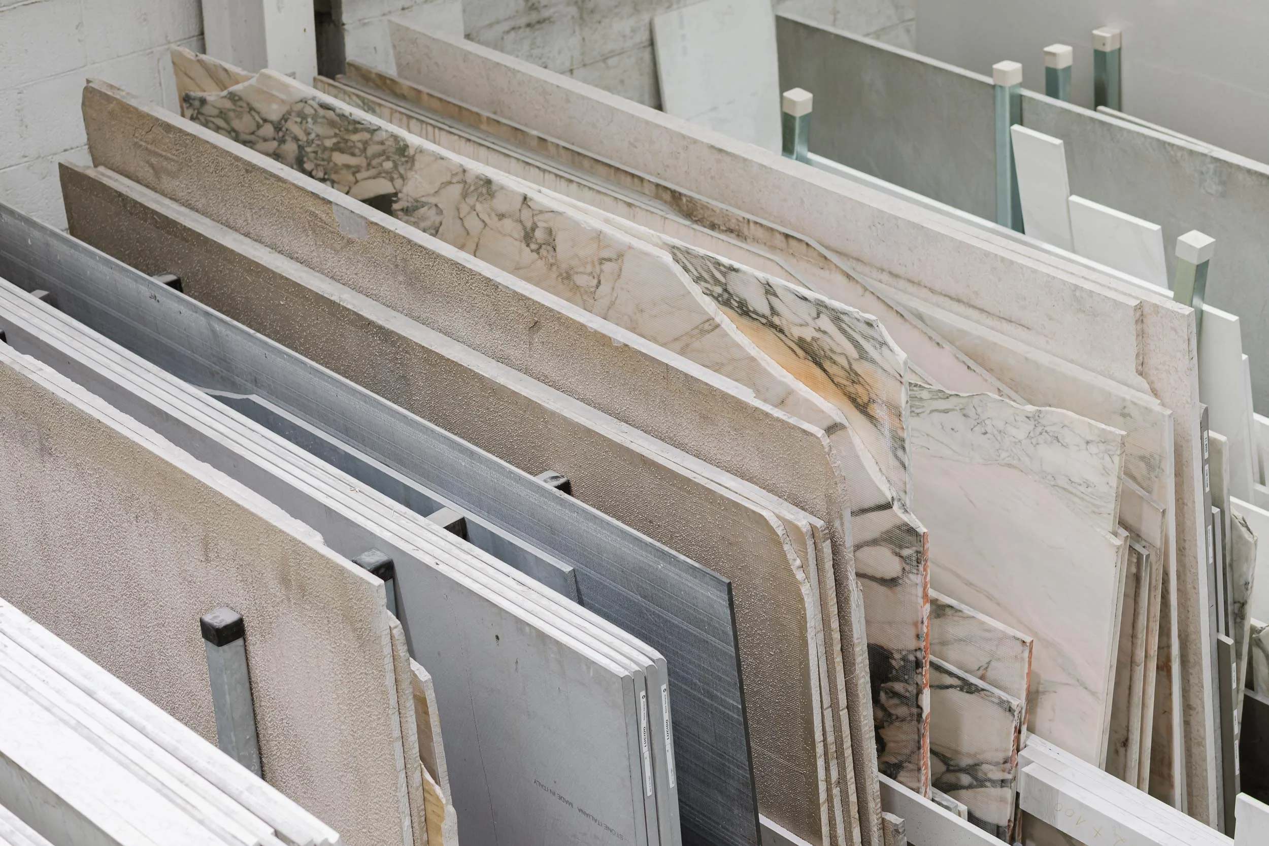 A display of various marble and stone slabs in different colors and patterns.
