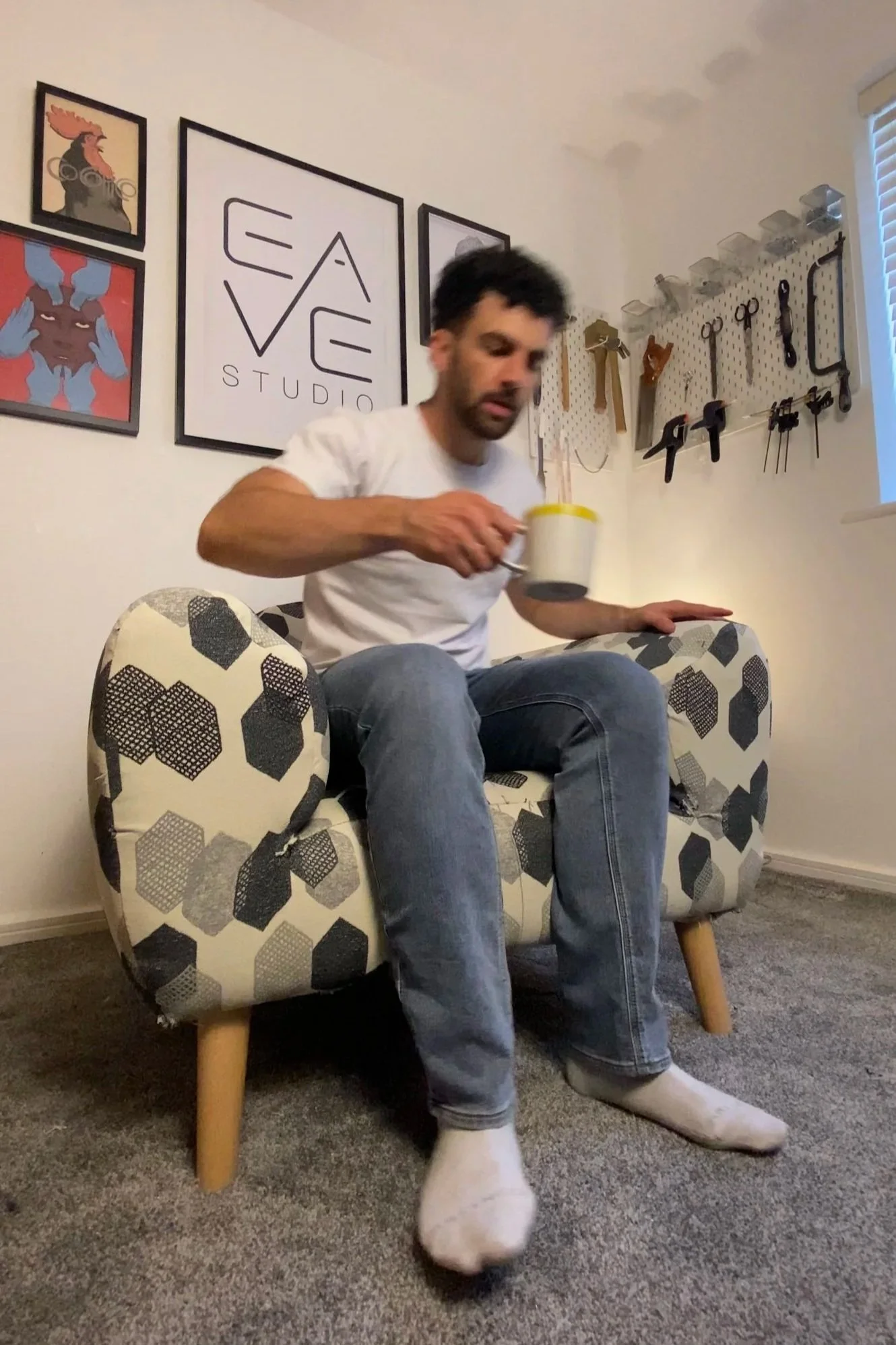sit testing the finished prototype chair with a cup of tea