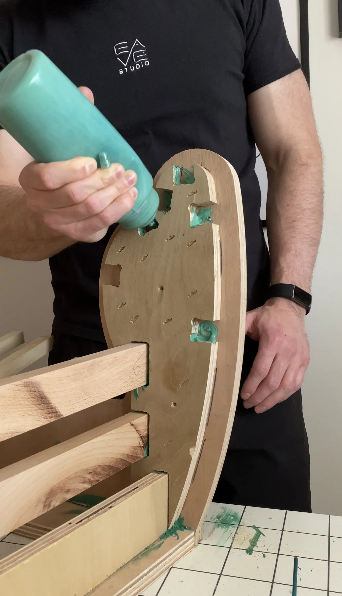wood glue being applied to a wooden chair frame during construction