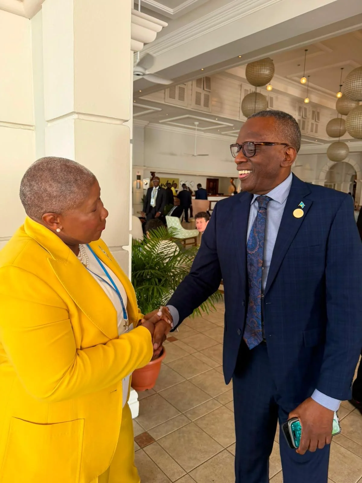 Dr. Eslene Shockley greets The Honourable Philip J. Pierre, M.P.