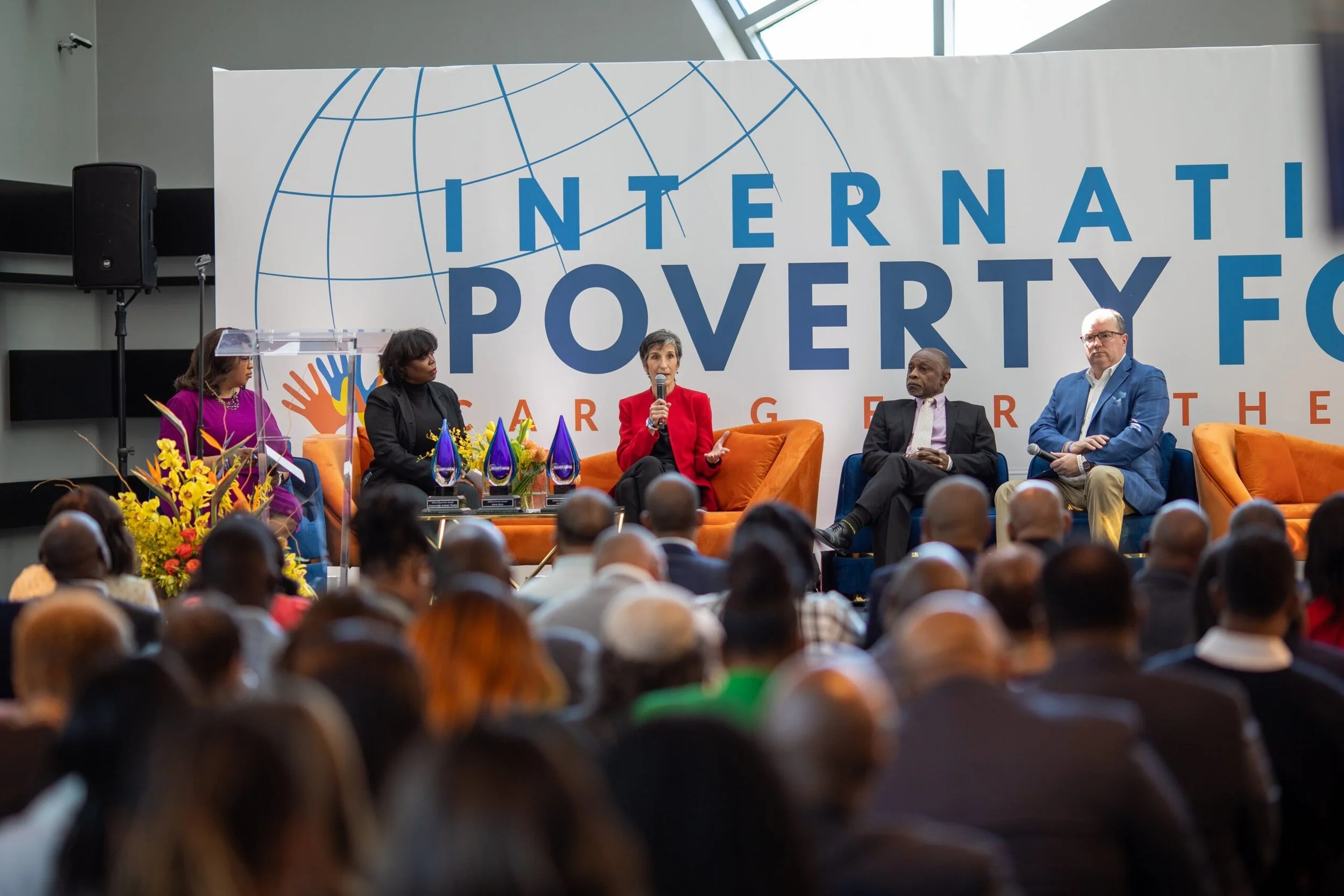 A full room listening to a panel at a past International Poverty Forum Assembly