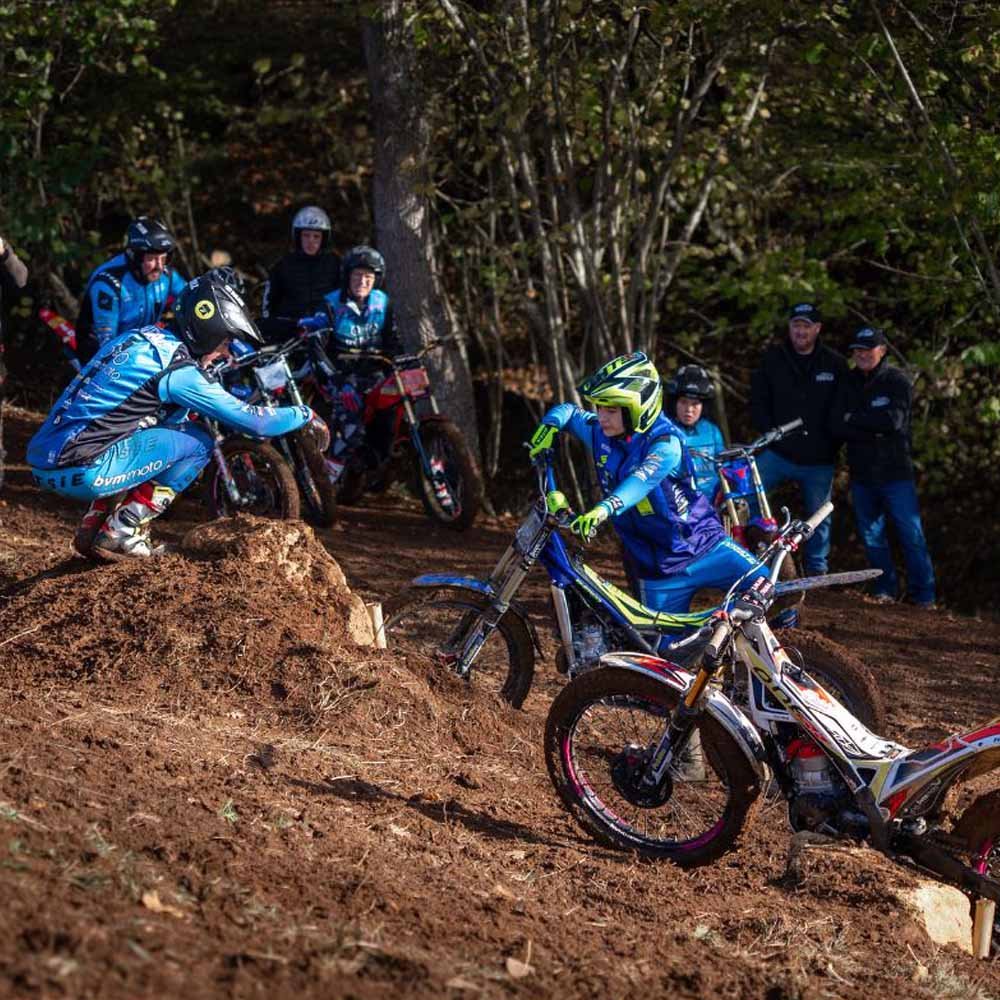Rider tackling muddy woodland section at Magnum Trials Centre 