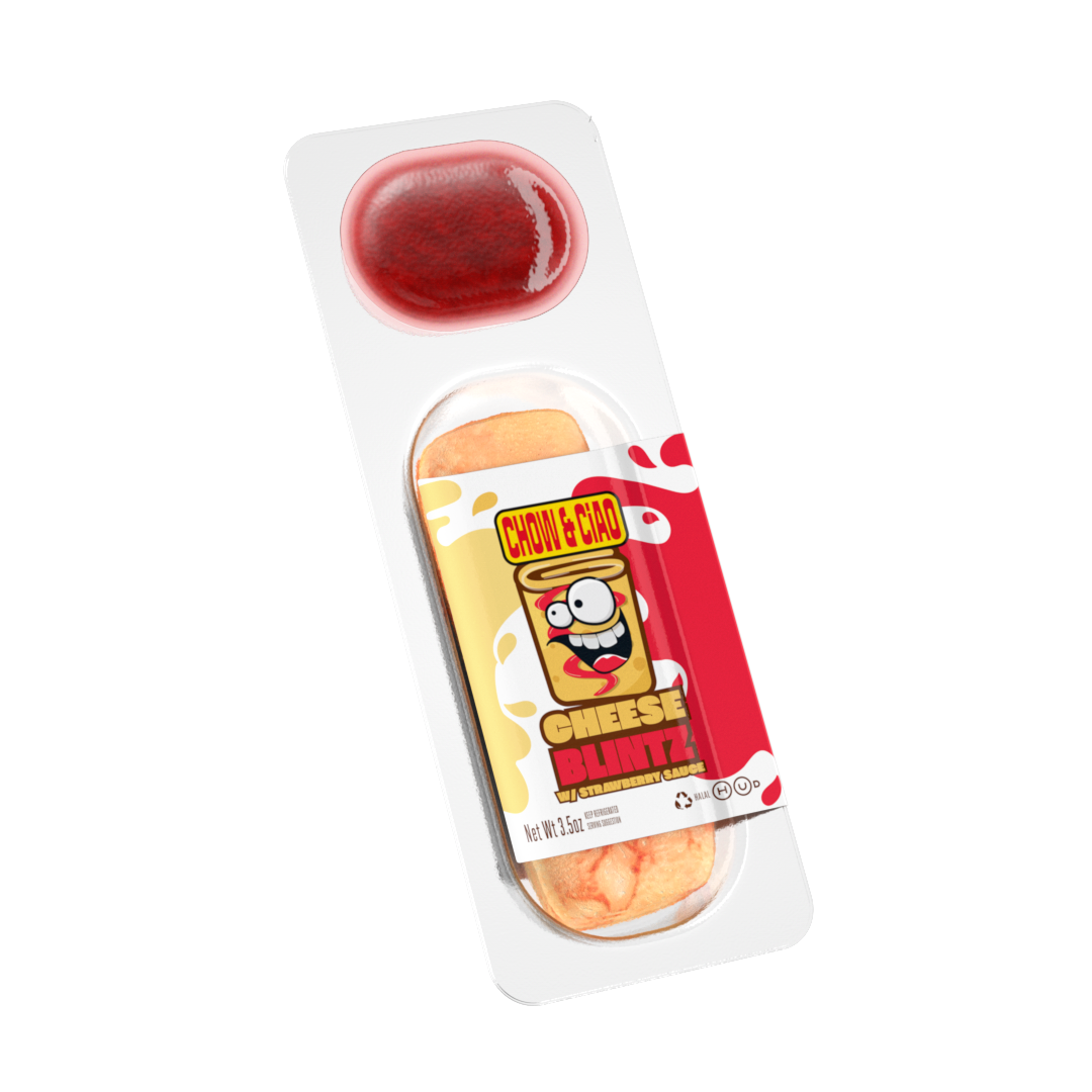 Blended strawberry sauce on top of a cheese and strawberry flavored snack in a clear plastic container with colorful cartoon label.