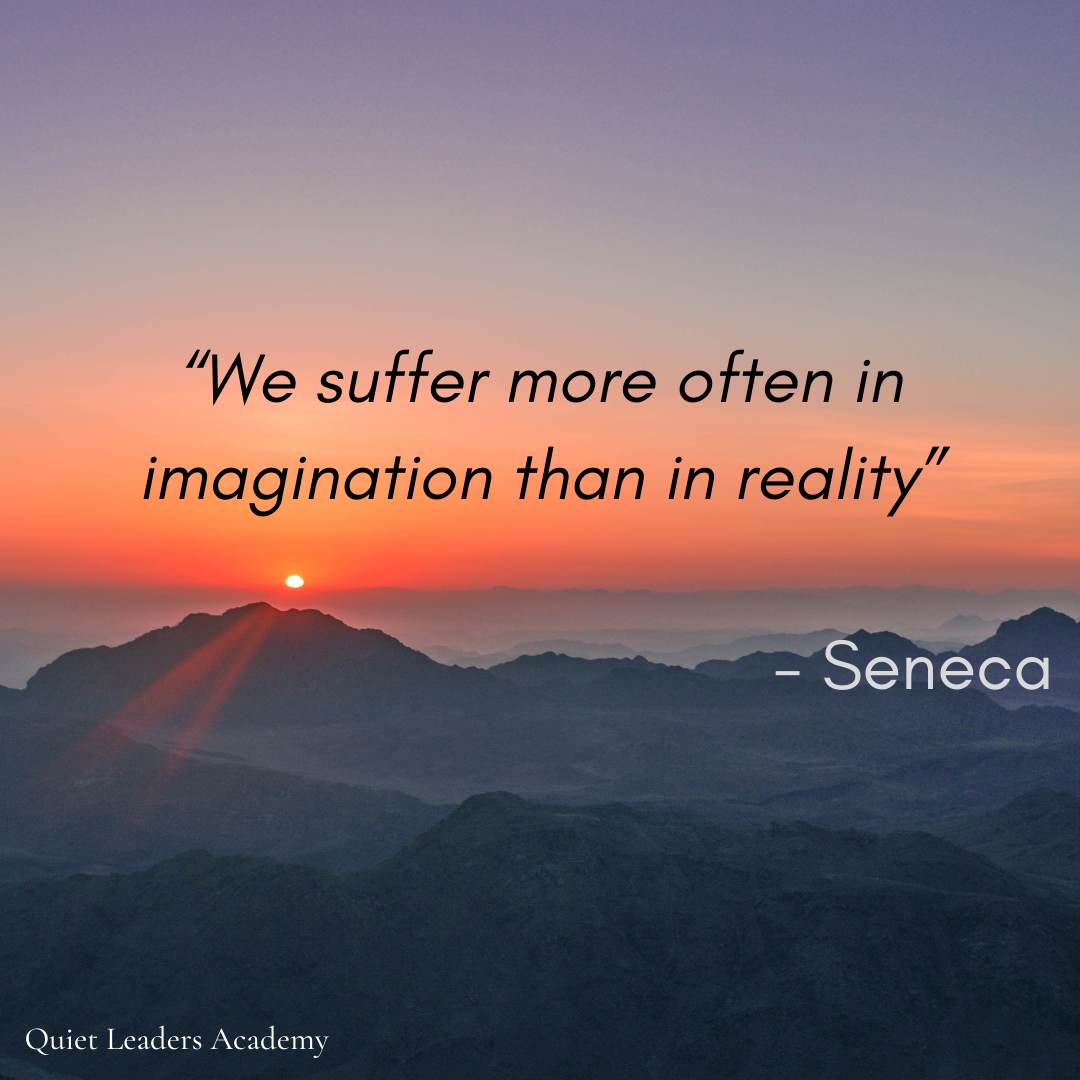 A sunset or sunrise over a mountain range with a quote by Seneca that reads, 'We suffer more often in imagination than in reality.'