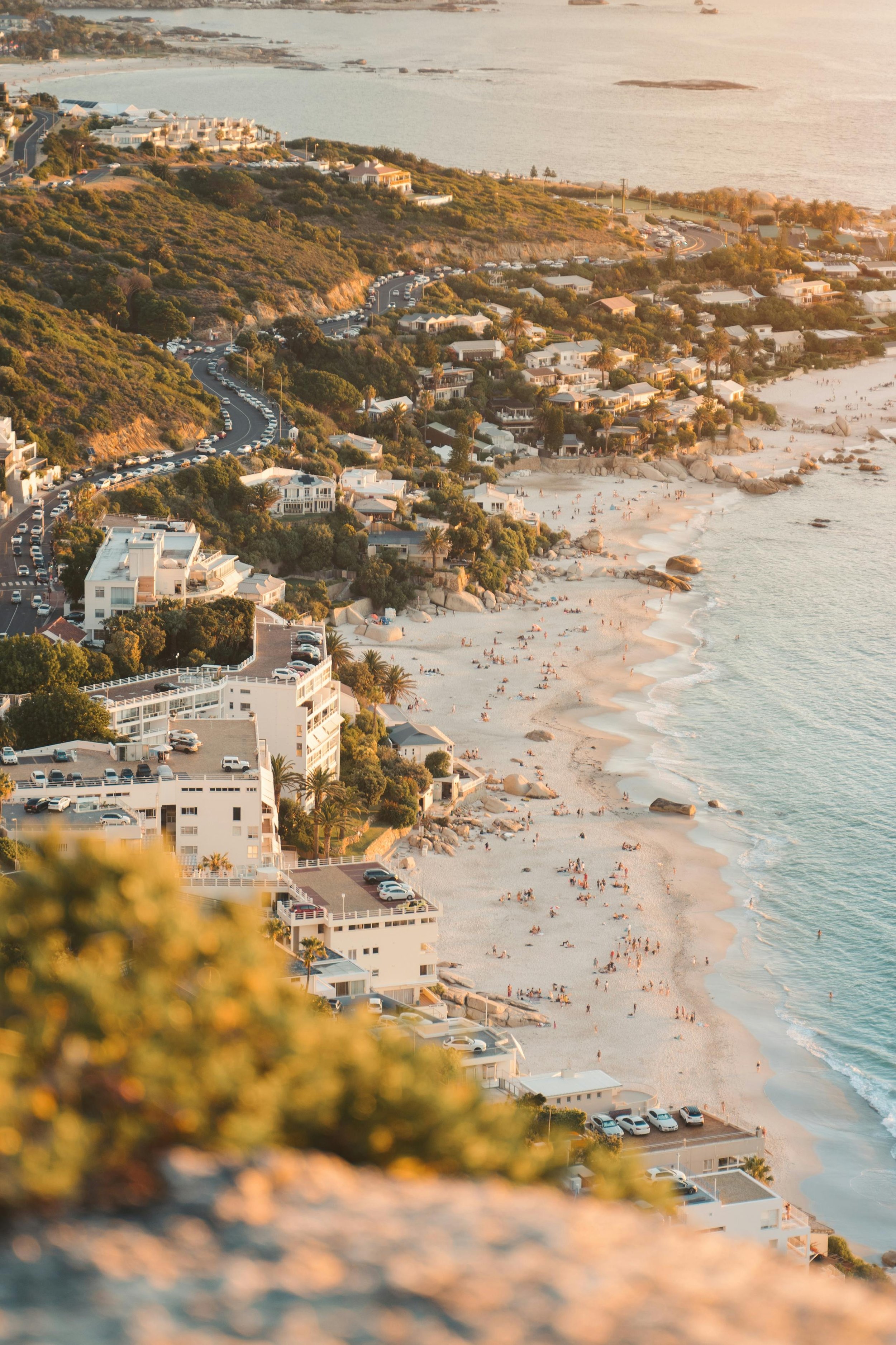 Coastal walkway overlooking Cape Town’s beaches and rocky shoreline at sunset.