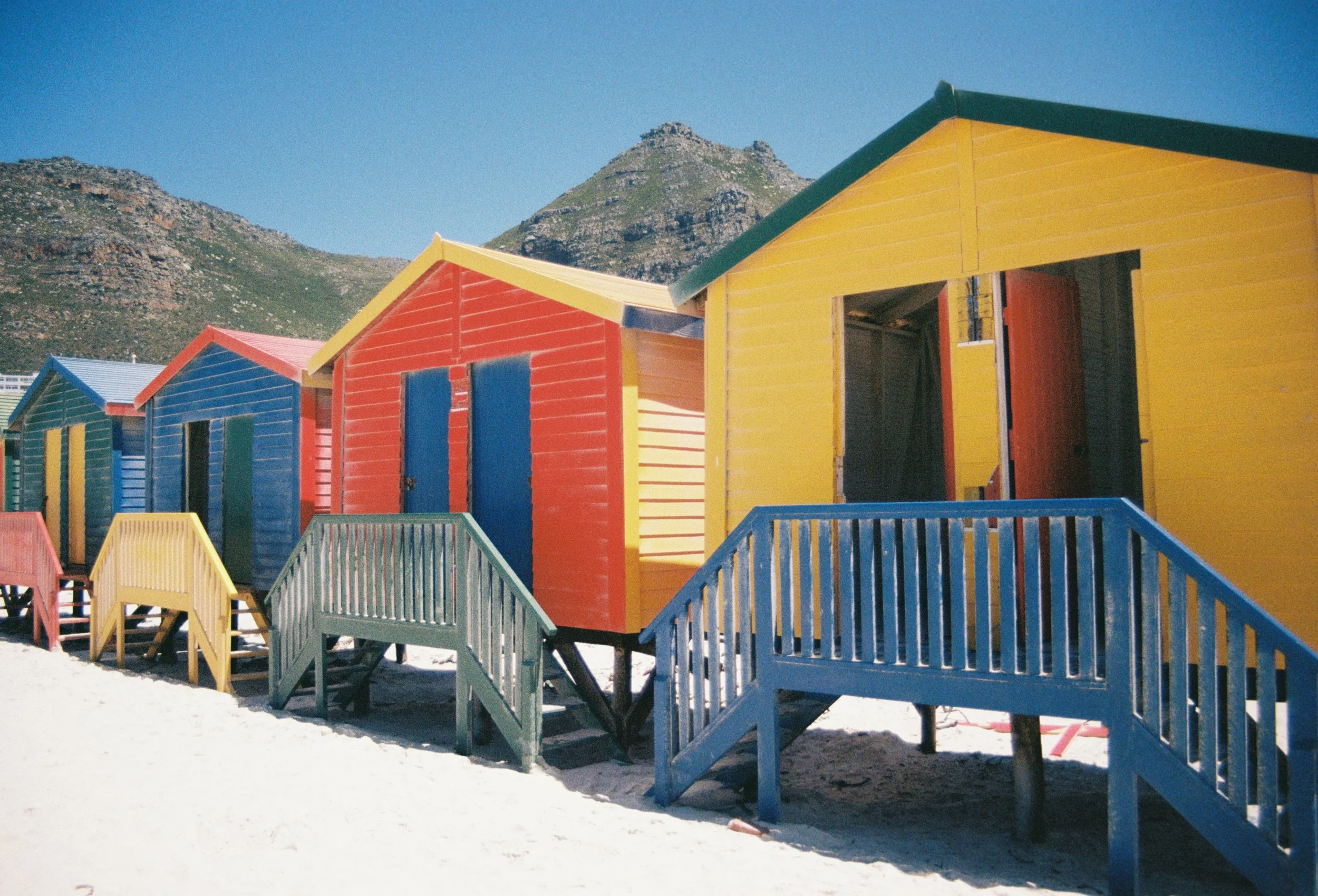 Colourful Muizenberg beach huts along the Cape Town coastline.