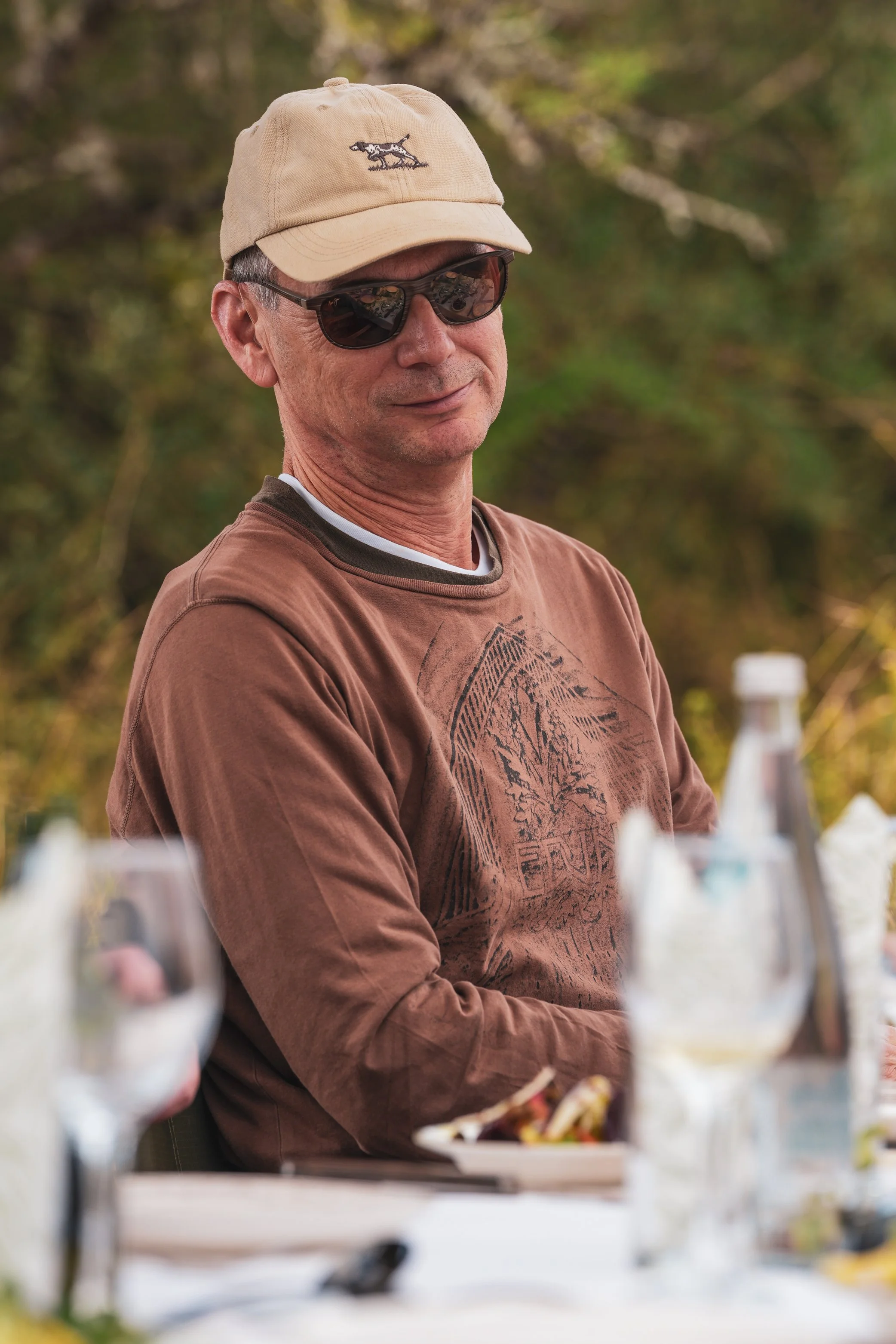 Guest seated outdoors during a Honey Guide safari experience at sunset.