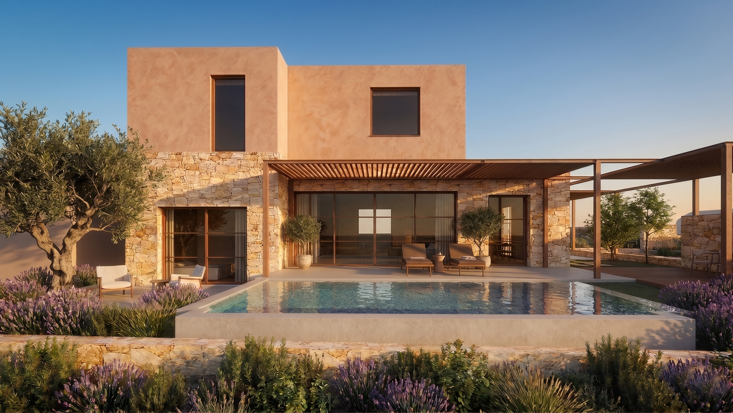 Modern house with stone and stucco exterior, outdoor patio with seating, swimming pool, and landscaped garden with purple flowers and trees, during sunset.