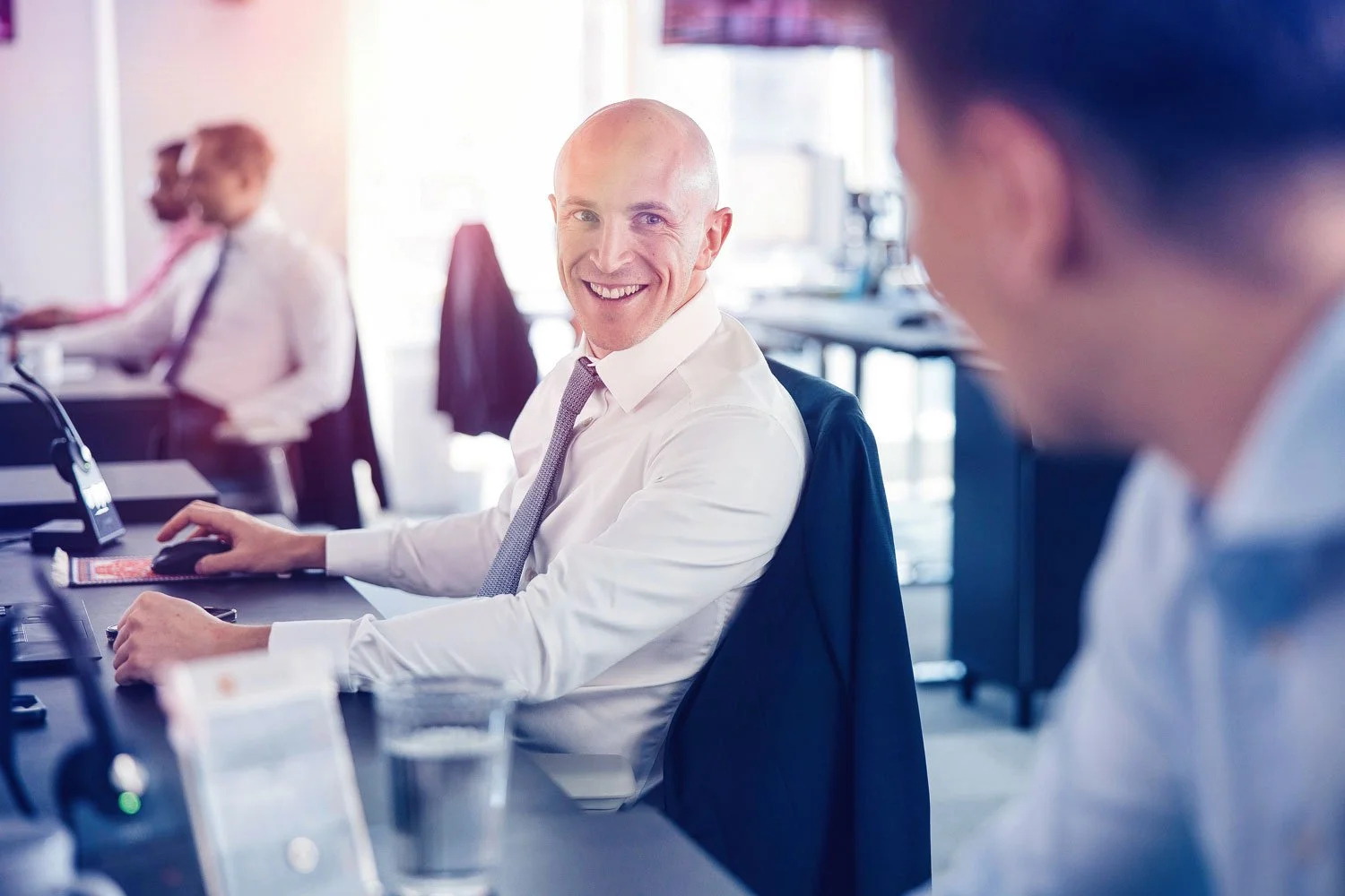 Business professionals collaborating in modern office environment captured for corporate lifestyle photography.