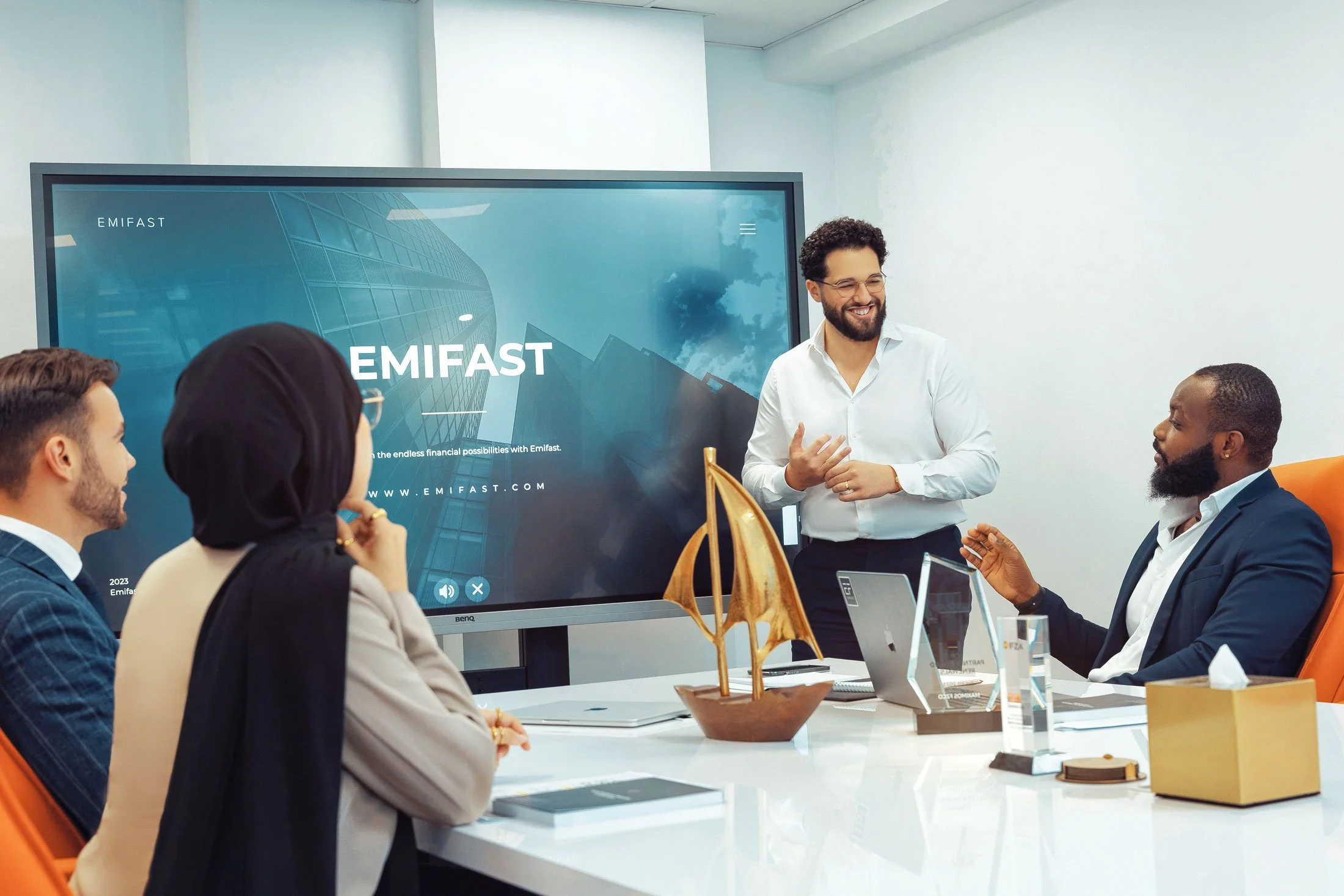 Business meeting scene showing professionals discussing project strategy in contemporary office setting.