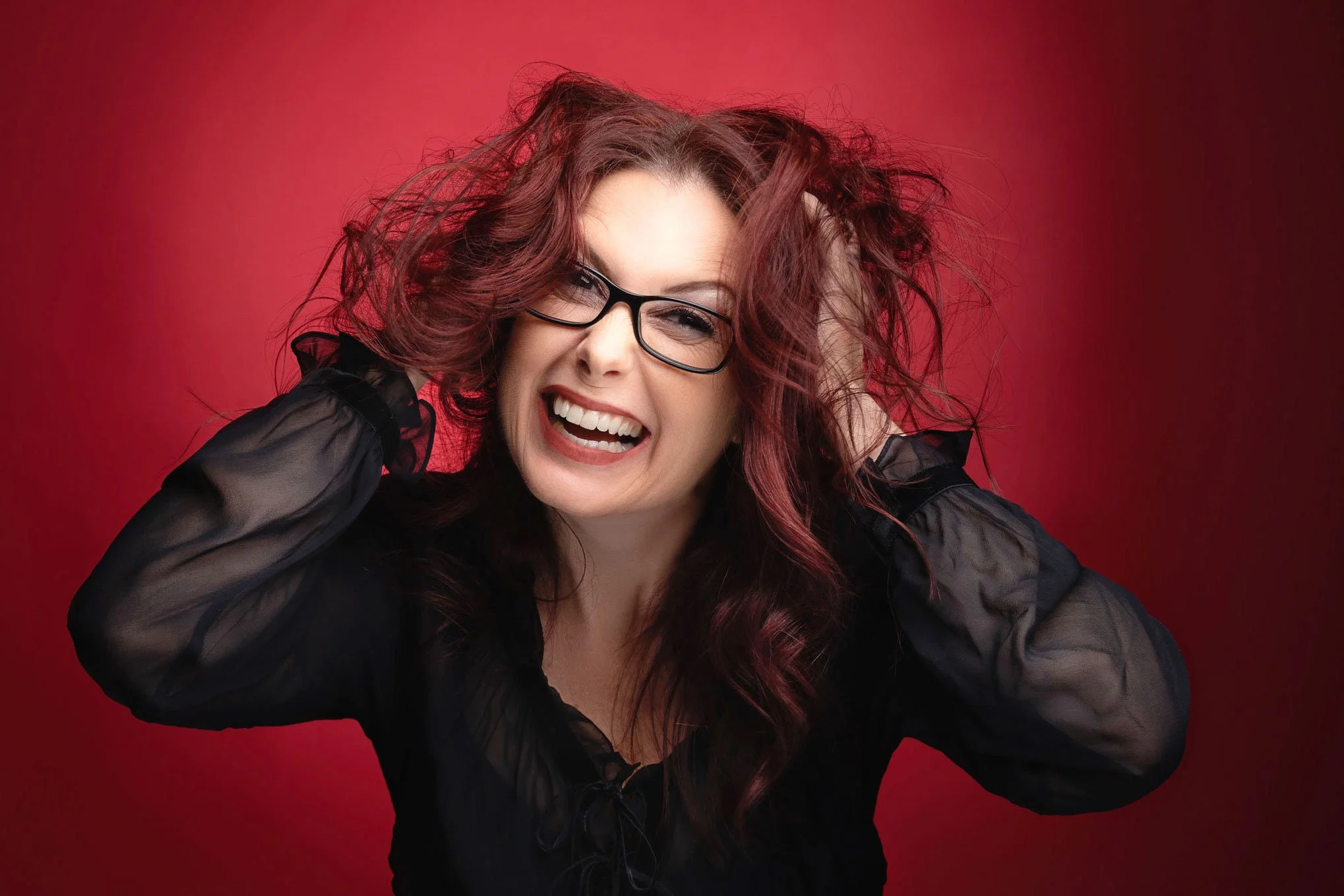 Studio Portrait of a women i funny way on red background. 