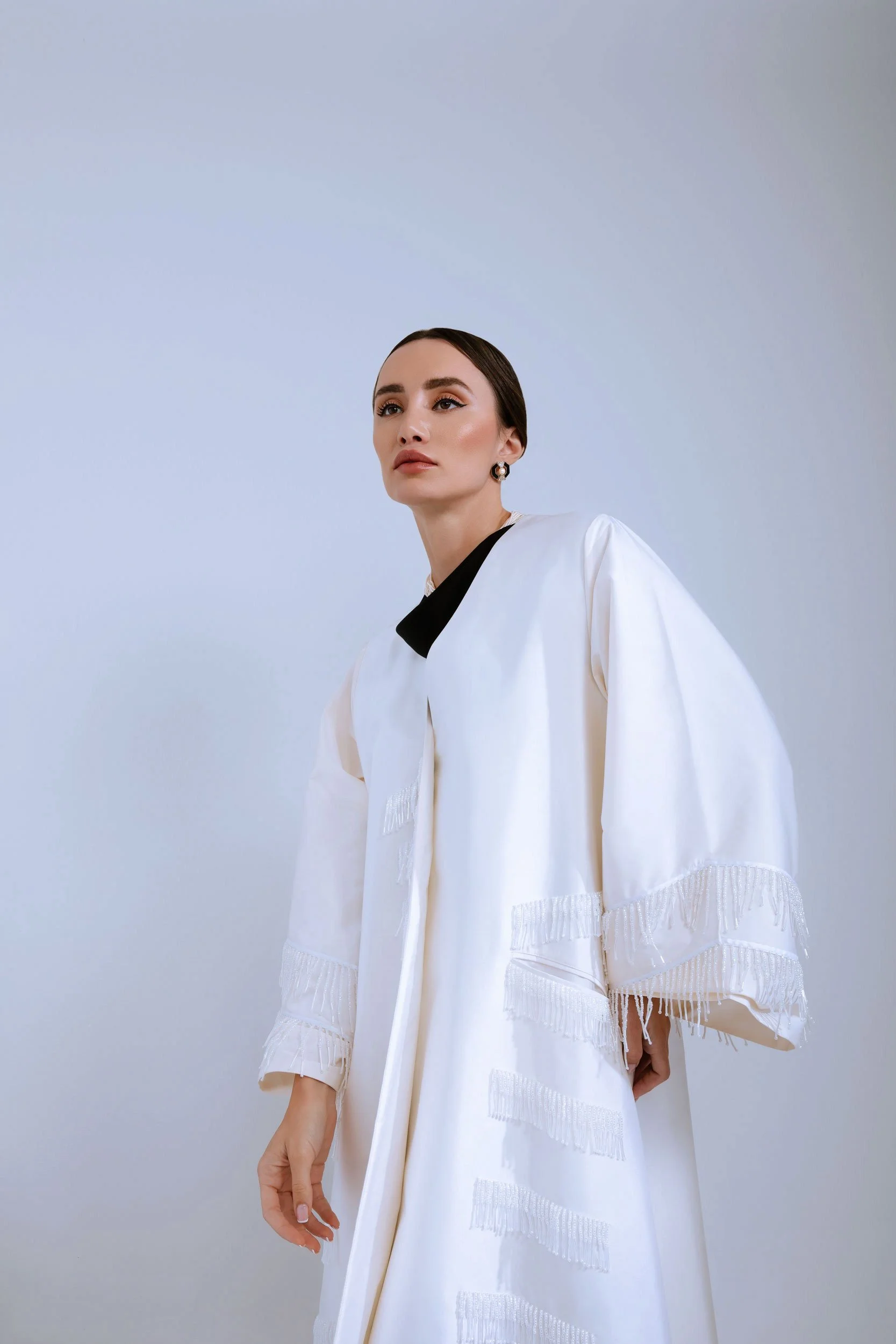 Studio fashion portrait photographed in Dubai with contemporary styling and clean background.