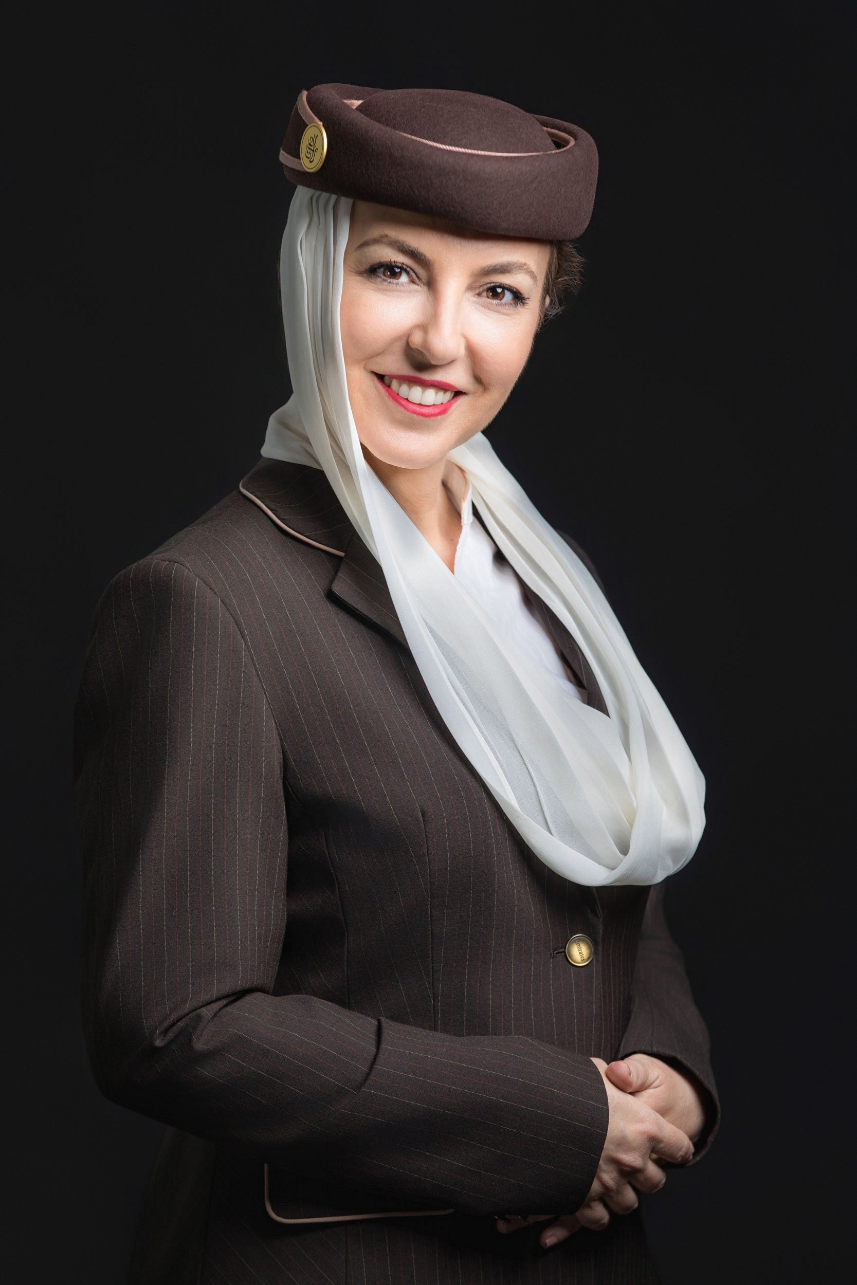 Corporate portrait photography in Dubai featuring an airline cabin crew member in professional uniform.
