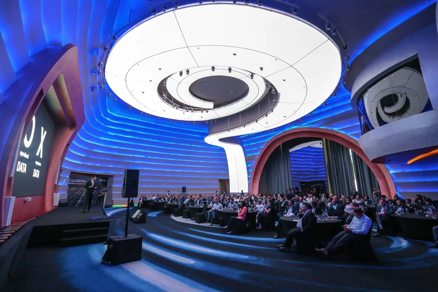 Large audience attending keynote session at international conference event.