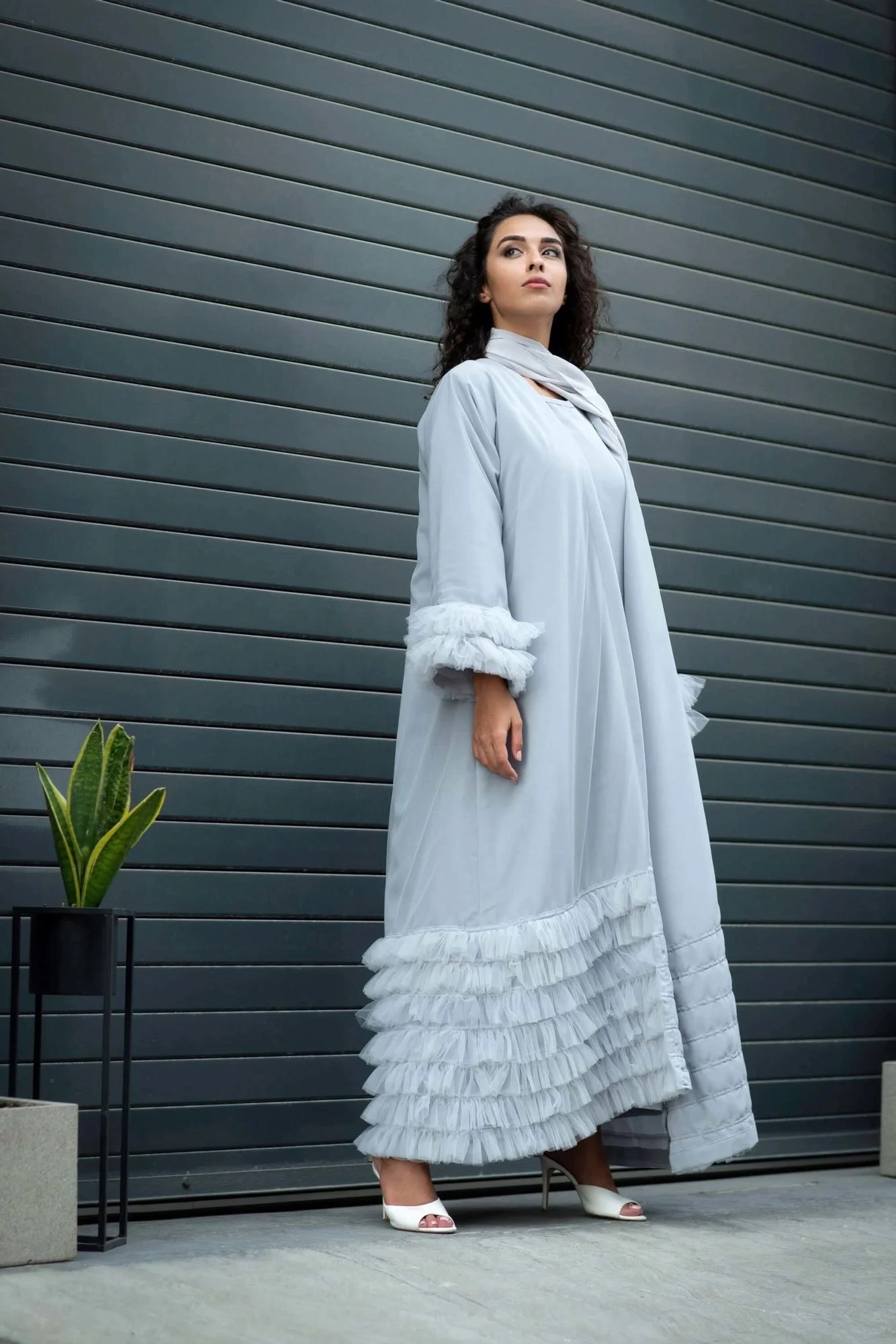 High fashion studio portrait photographed with cinematic lighting and textured backdrop.